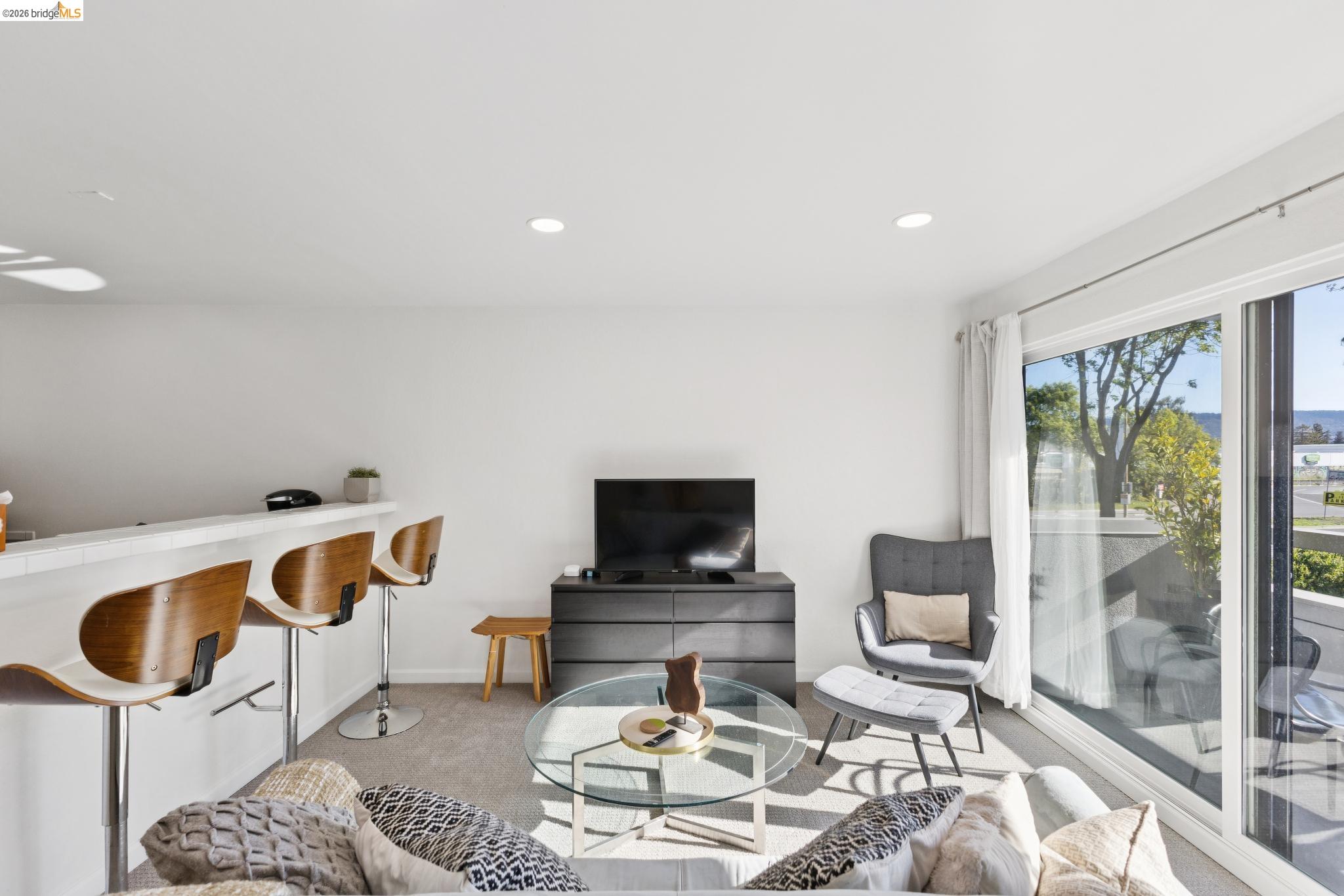 5 Embarcadero, Unit 129 Oakland, CA 94607 - Photo 10 of 32 Living room with light colored carpet and recessed lighting