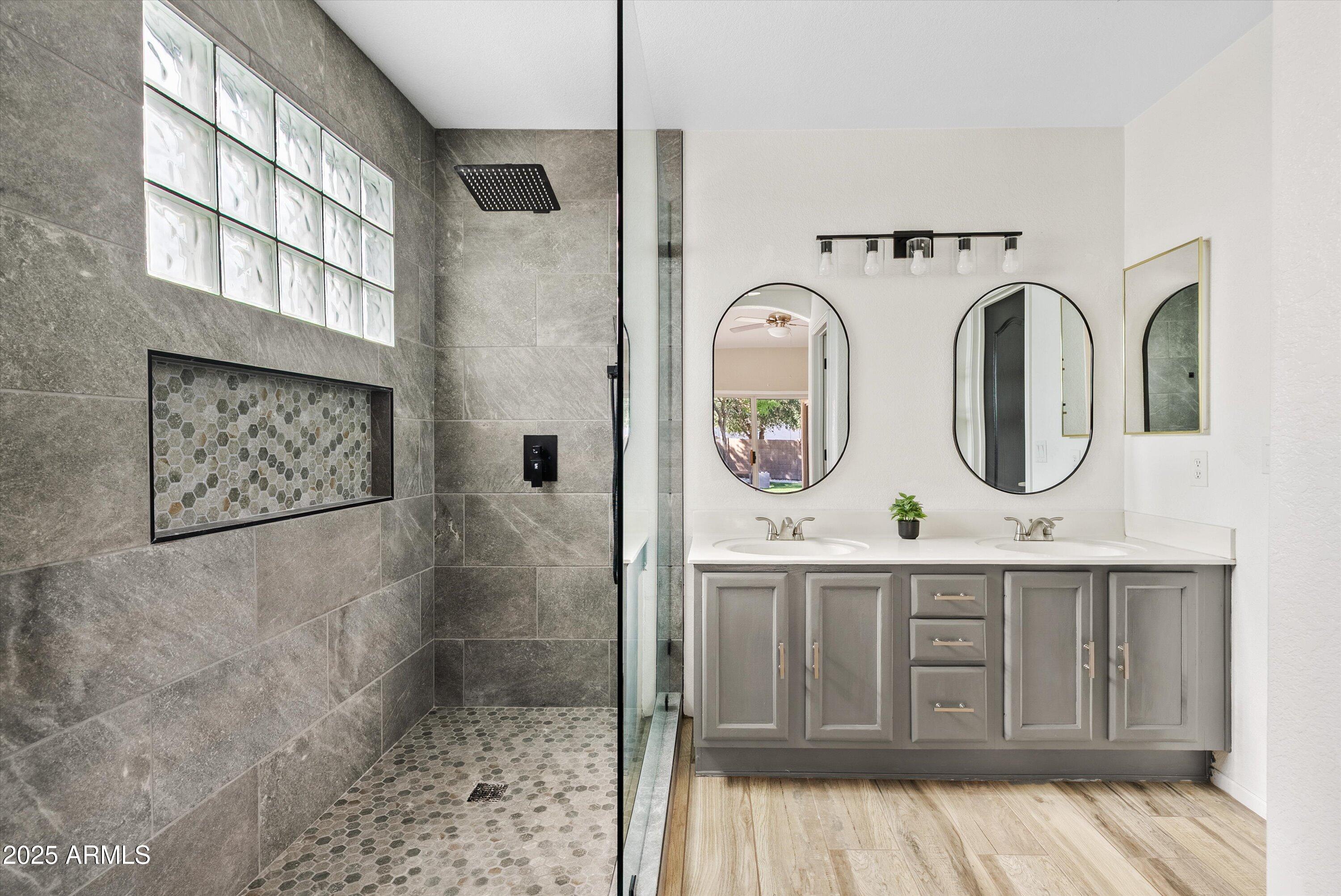 545 South Ash Street Gilbert, AZ 85233 - Photo 16 of 38 a bathroom with a sink a mirror and shower