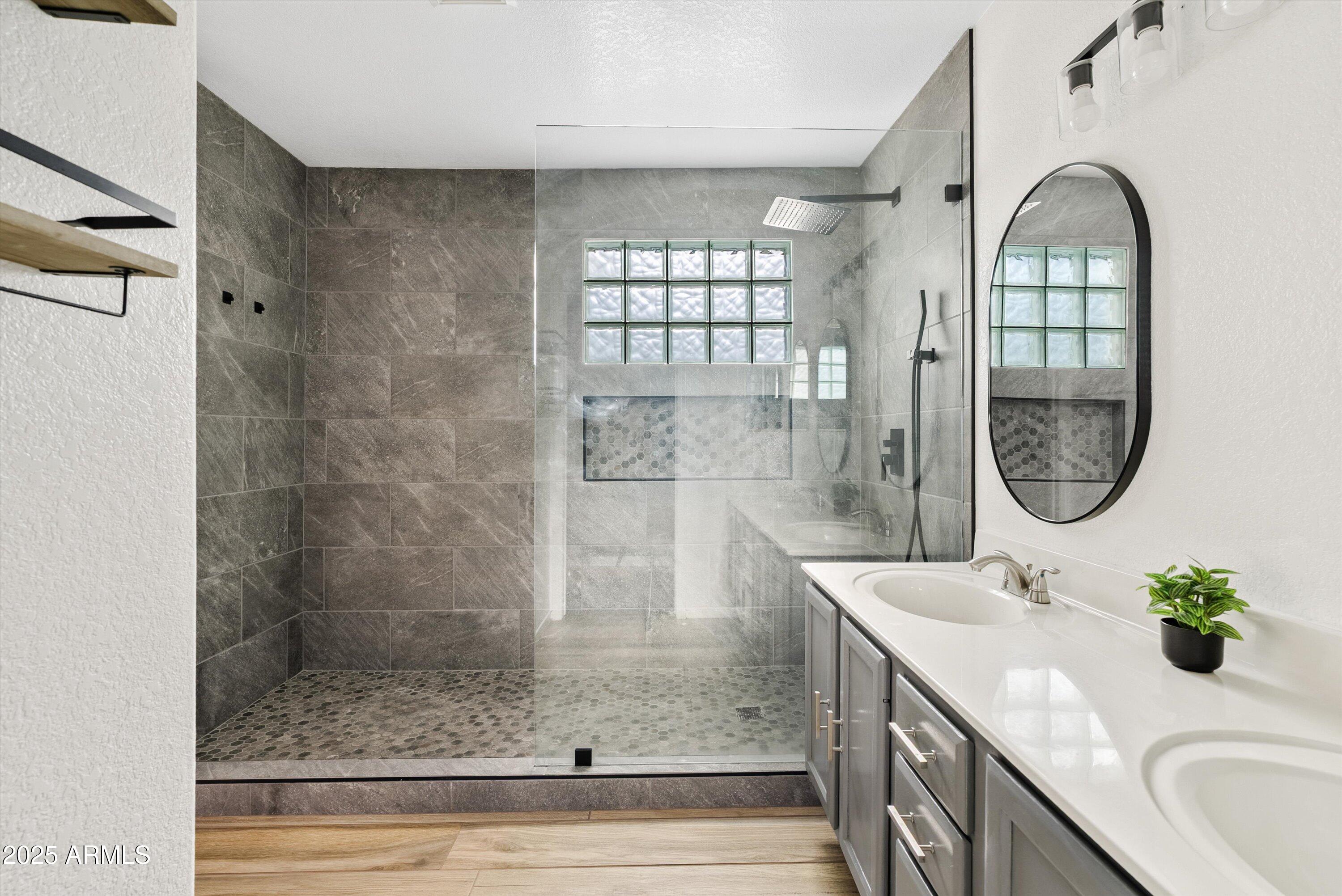 545 South Ash Street Gilbert, AZ 85233 - Photo 17 of 38 a bathroom with a granite countertop sink a mirror and a shower