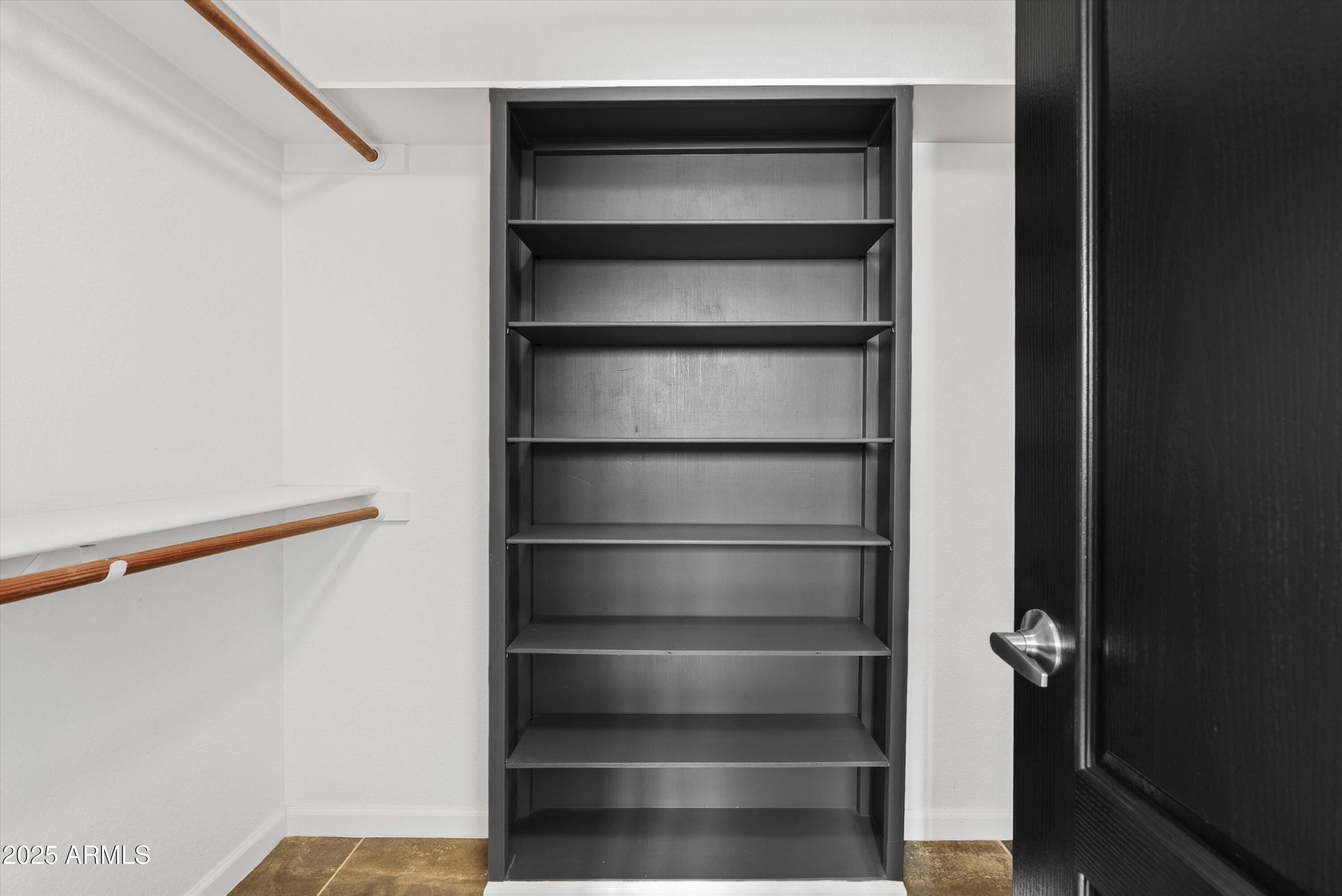 545 South Ash Street Gilbert, AZ 85233 - Photo 18 of 38 a view of walk in closet with empty racks