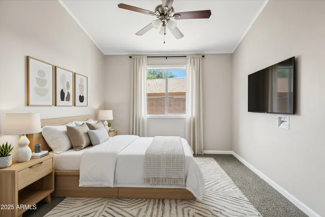 an empty room with a window and a ceiling fan
