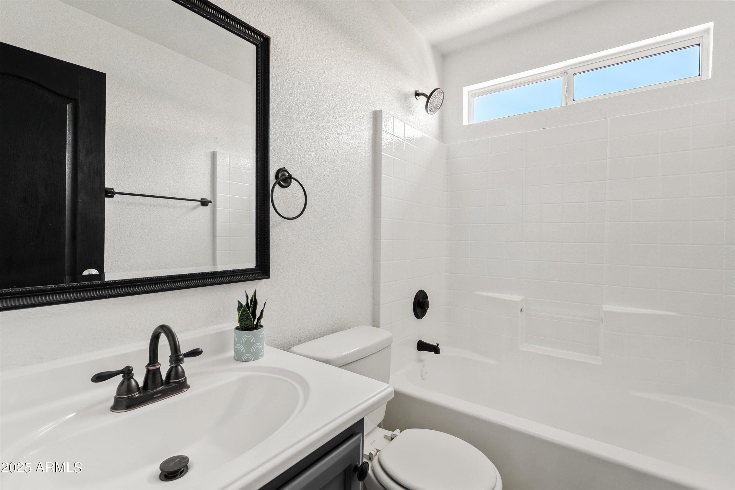 545 South Ash Street Gilbert, AZ 85233 - Photo 22 of 38 a bathroom with a sink toilet a mirror and shower