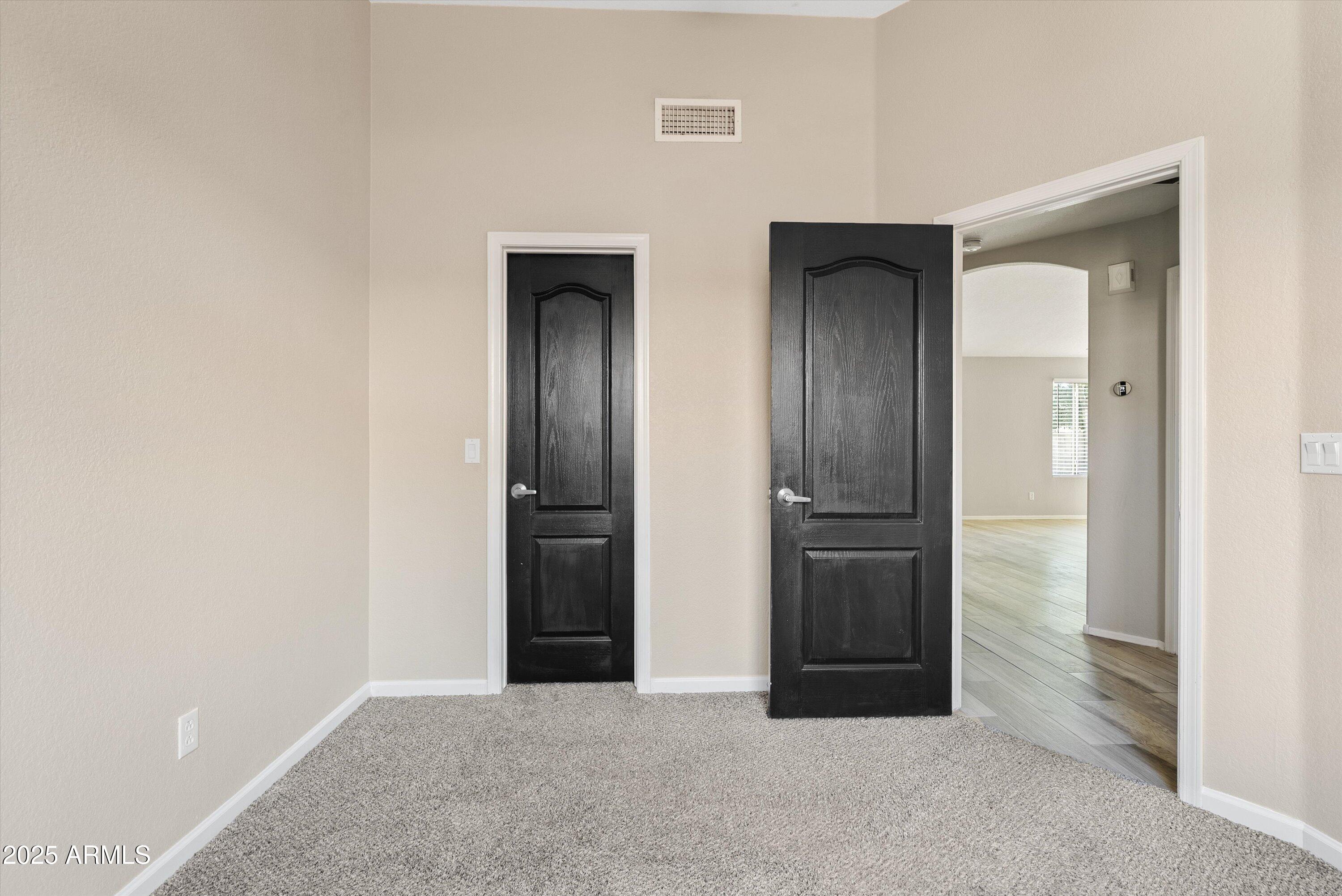 545 South Ash Street Gilbert, AZ 85233 - Photo 24 of 38 an empty room with closet and wooden door