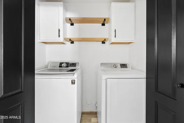 an empty room with closet and wooden door