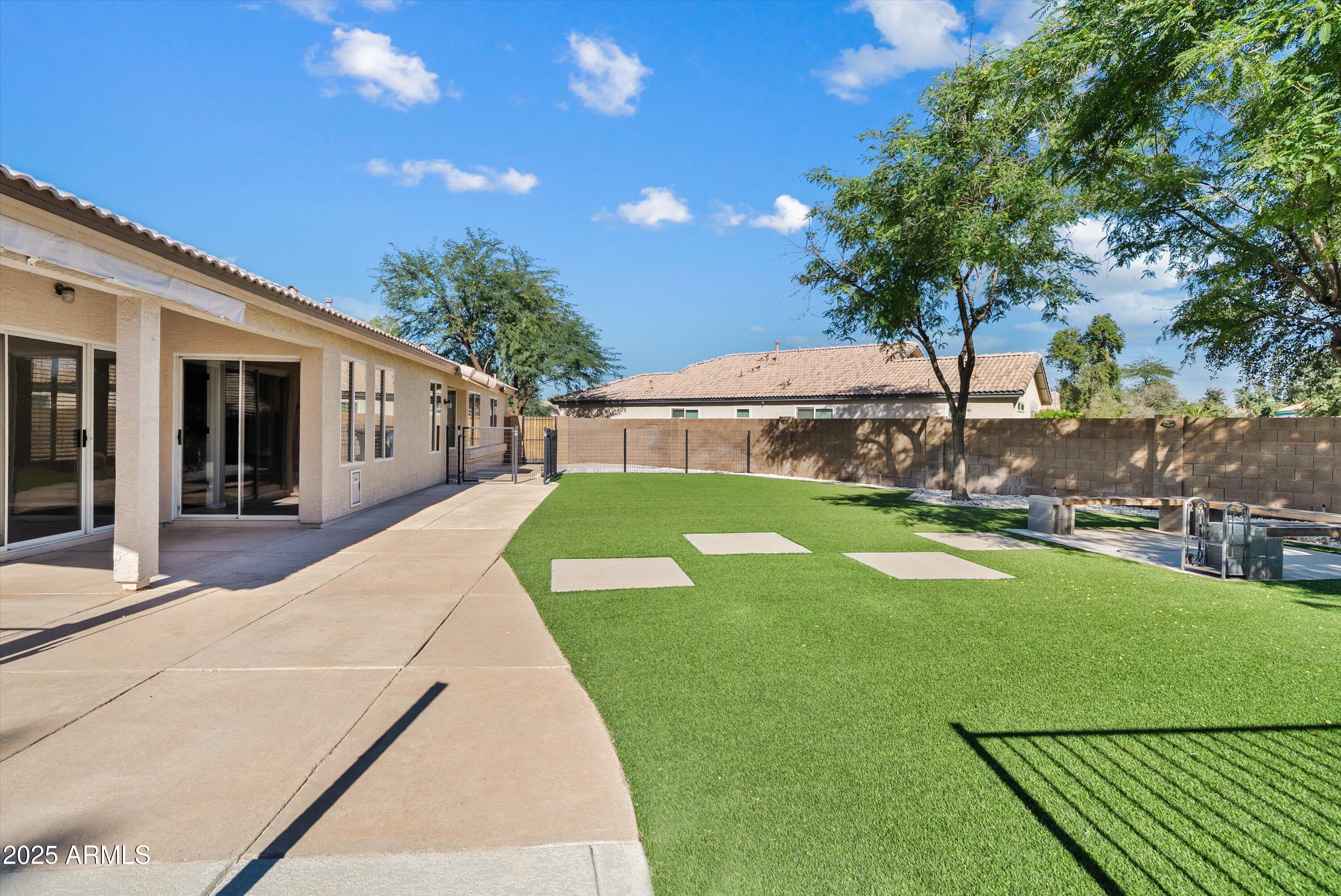 545 South Ash Street Gilbert, AZ 85233 - Photo 31 of 38 a view of backyard with swimming pool and patio