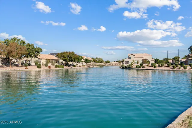 a view of a lake with houses in the background