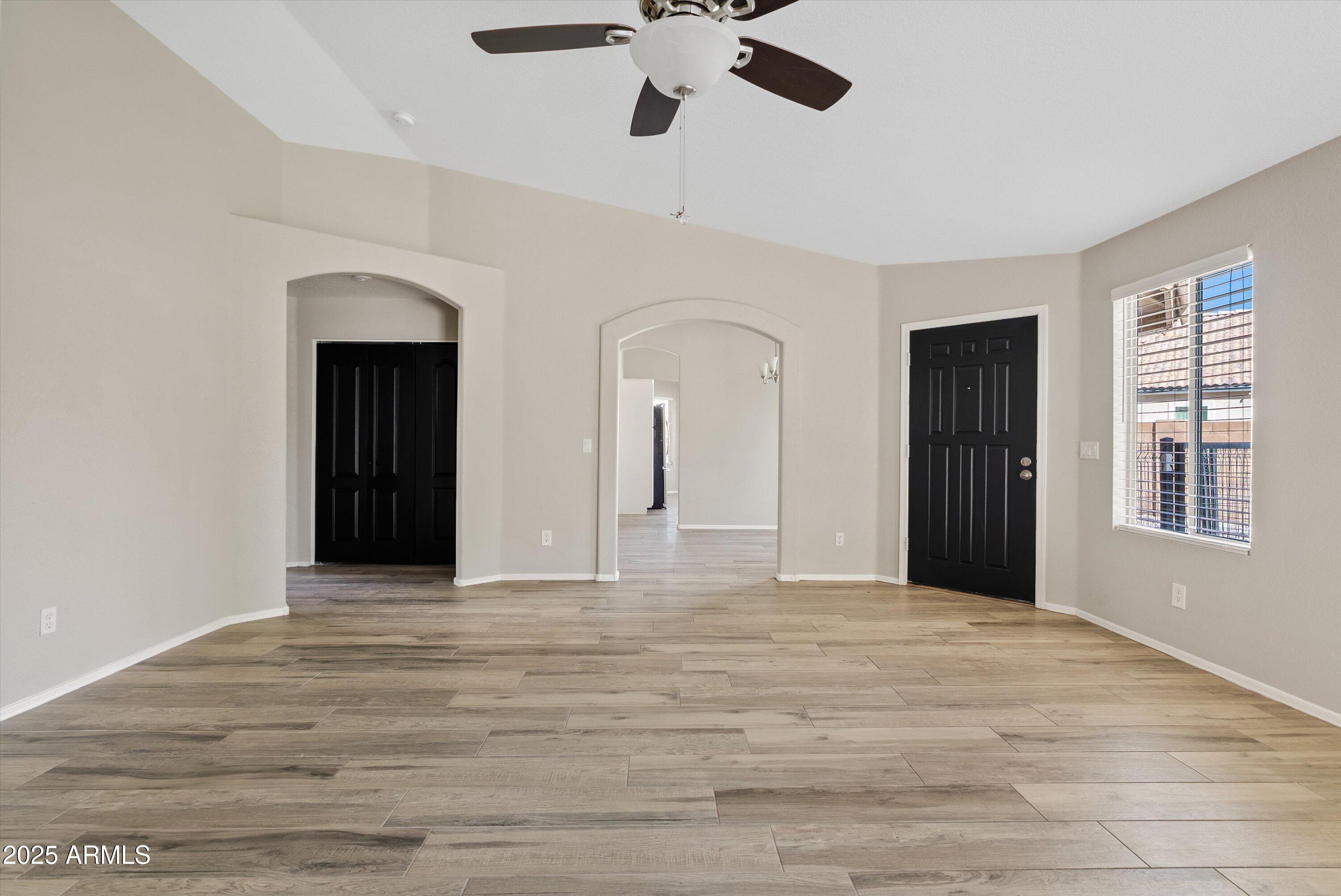 545 South Ash Street Gilbert, AZ 85233 - Photo 4 of 38 a view of an empty room with window and wooden floor
