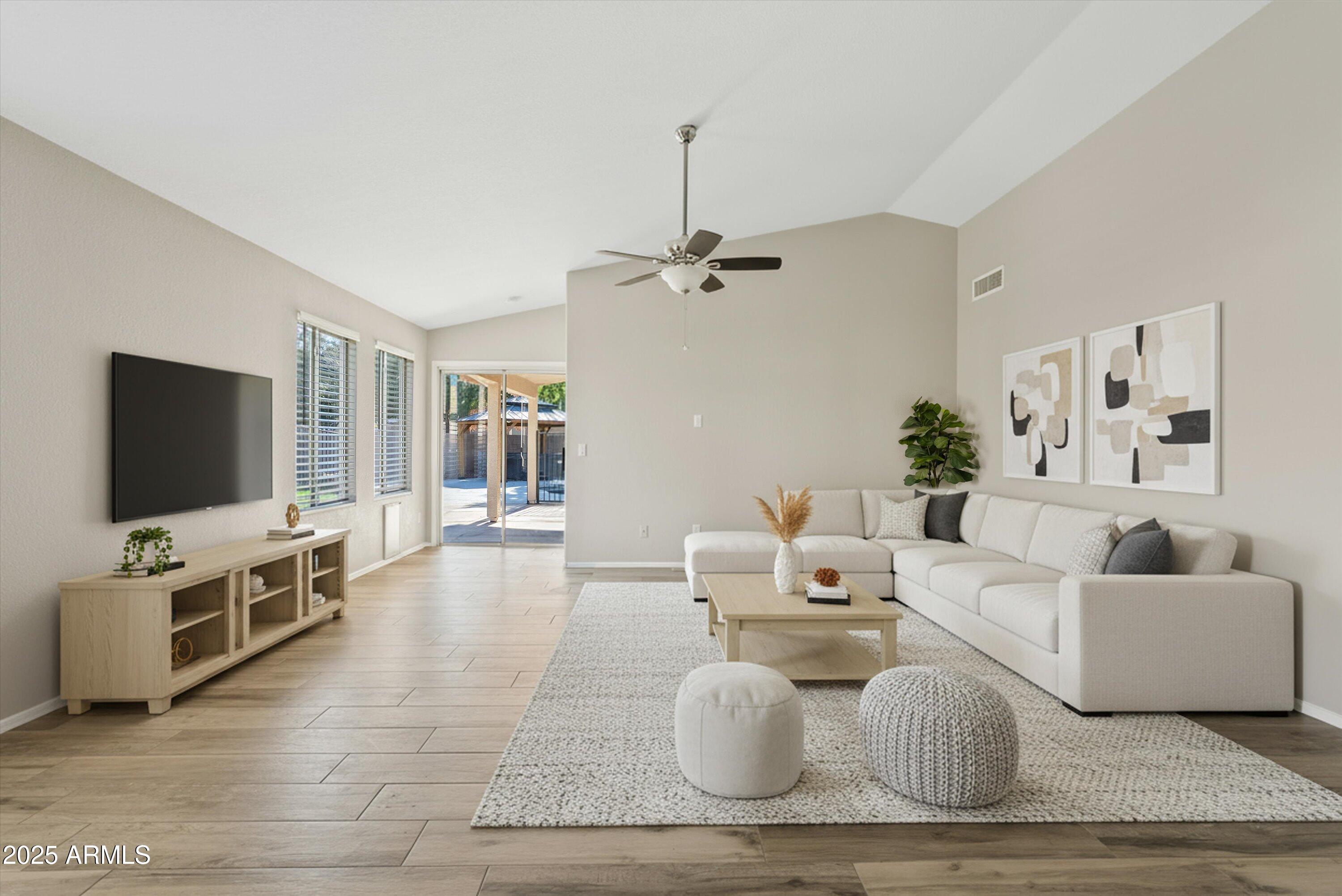 545 South Ash Street Gilbert, AZ 85233 - Photo 6 of 38 a living room with furniture and a flat screen tv