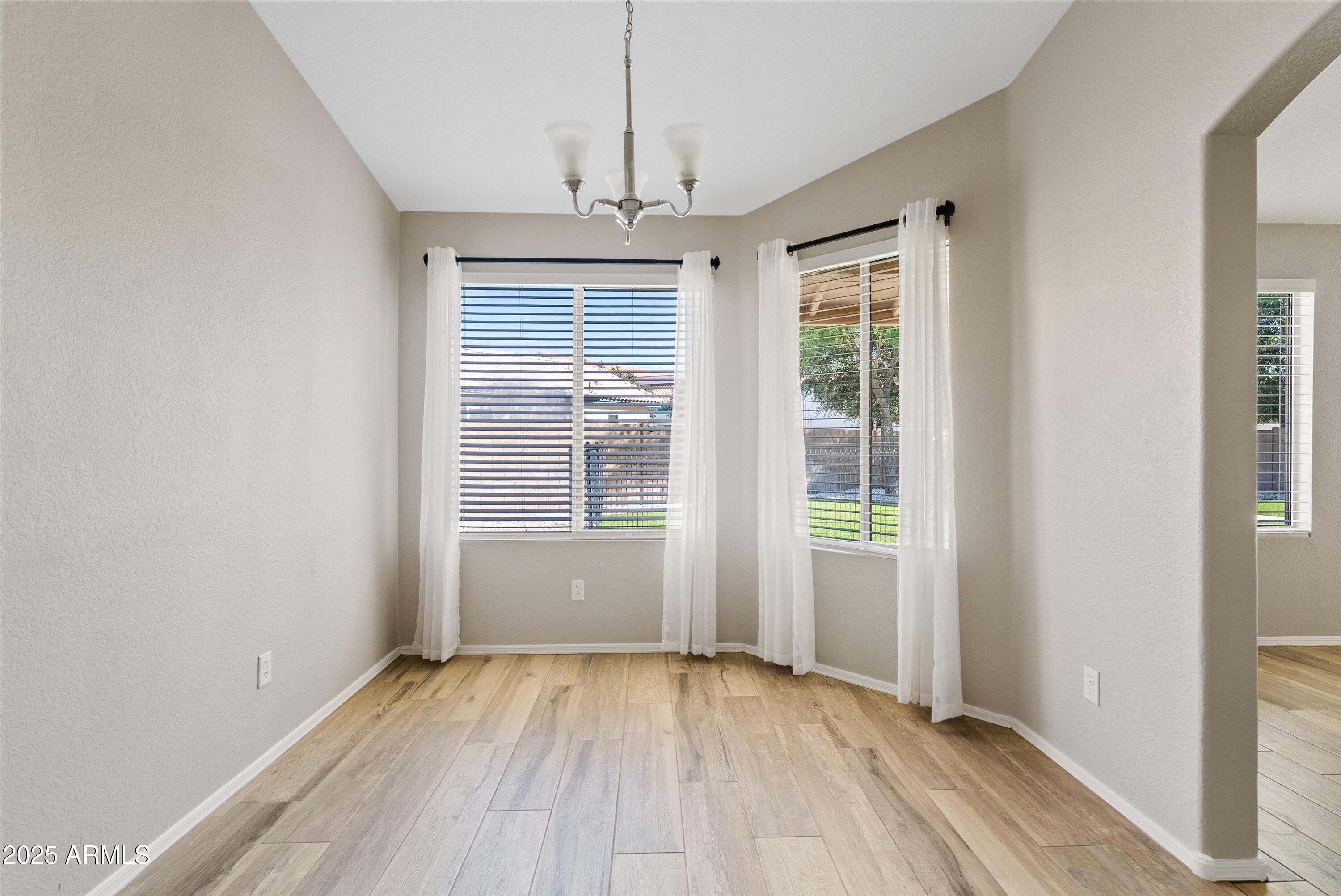 545 South Ash Street Gilbert, AZ 85233 - Photo 7 of 38 an empty room with wooden floor and windows
