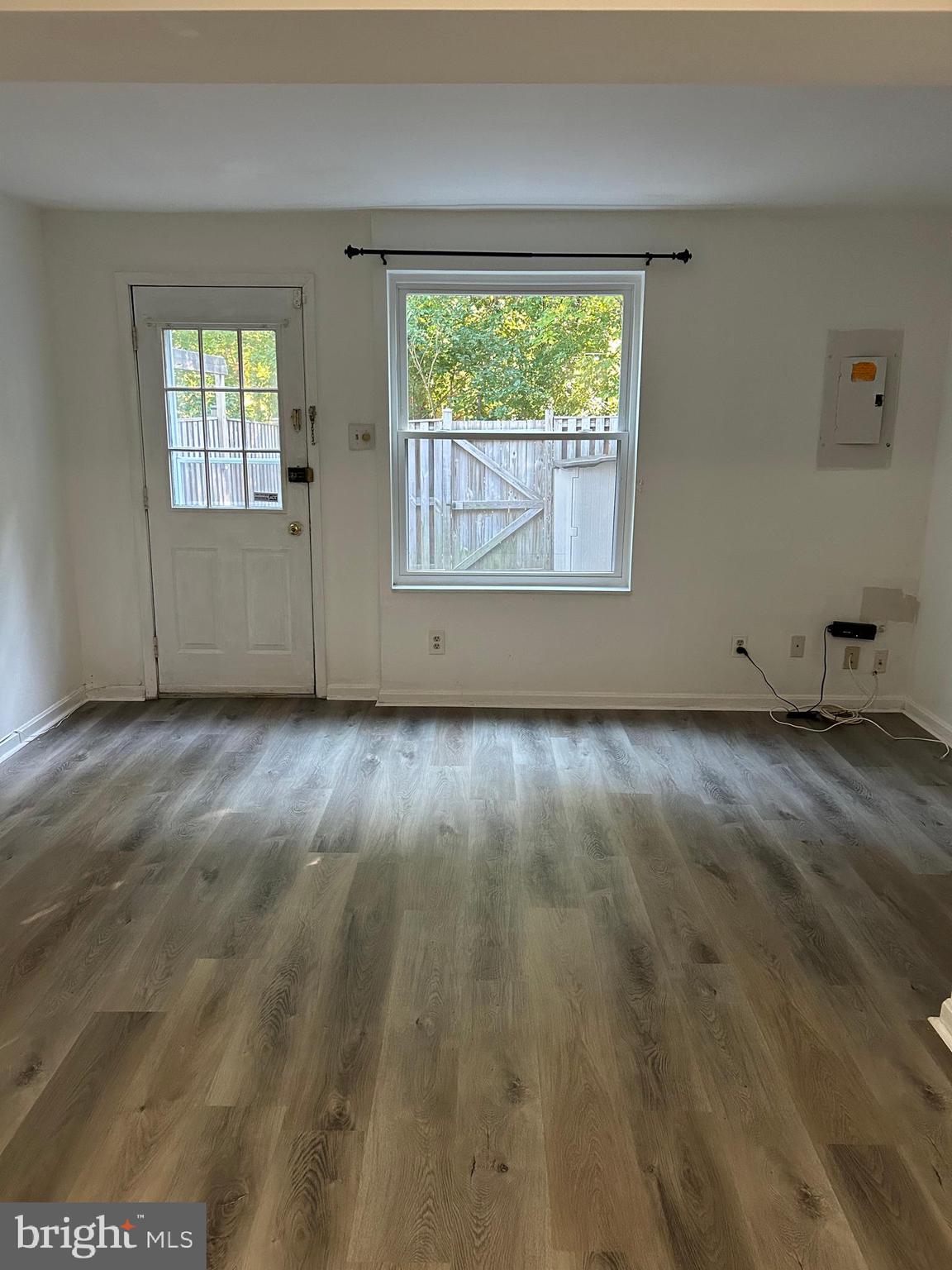 8315 Brookvale Court Springfield, VA 22153 - Photo 11 of 24 an empty room with wooden floor and windows