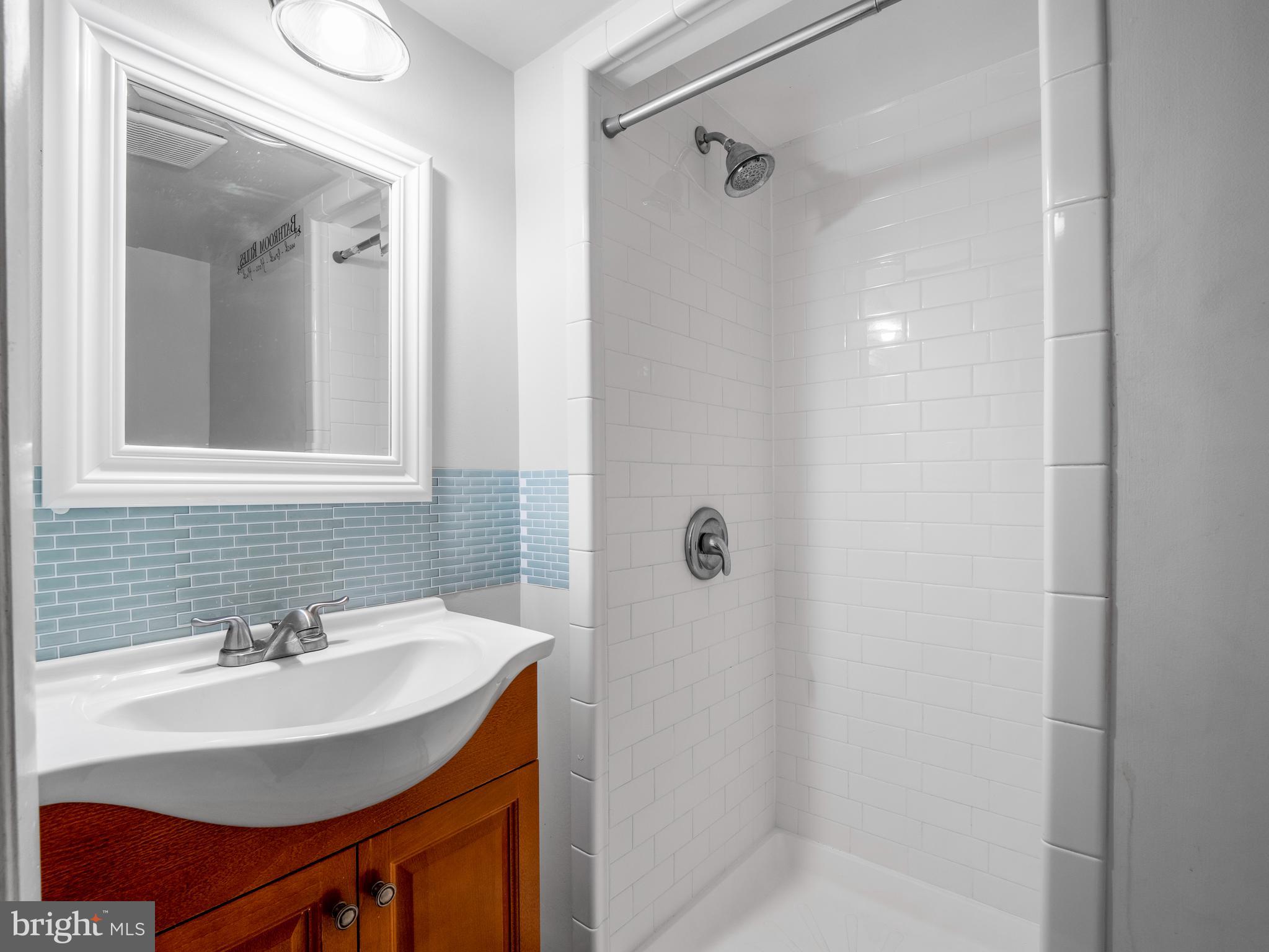 8315 Brookvale Court Springfield, VA 22153 - Photo 12 of 24 a bathroom with a sink shower and a mirror