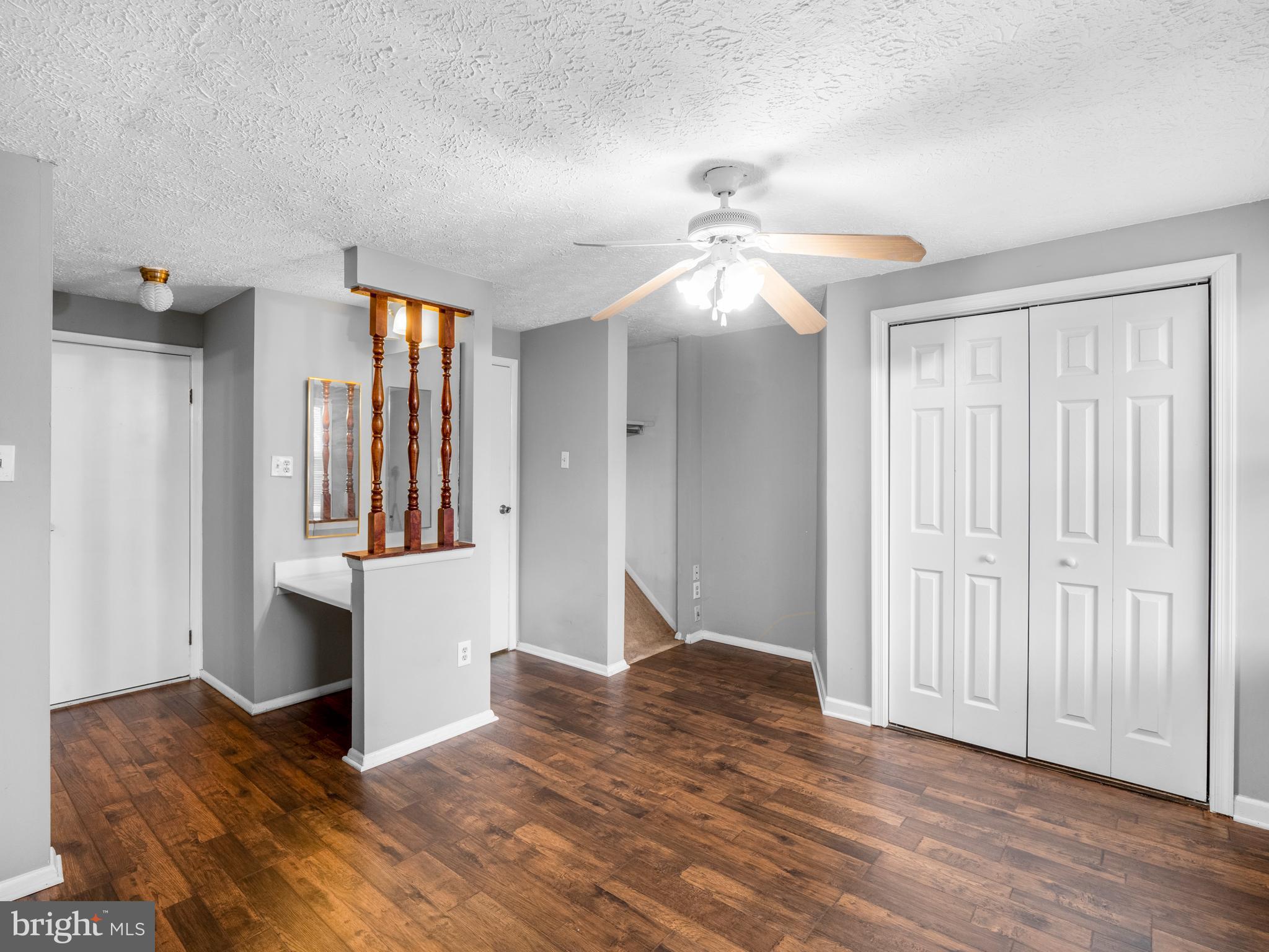 8315 Brookvale Court Springfield, VA 22153 - Photo 15 of 24 a view of empty room with wooden floor and fan