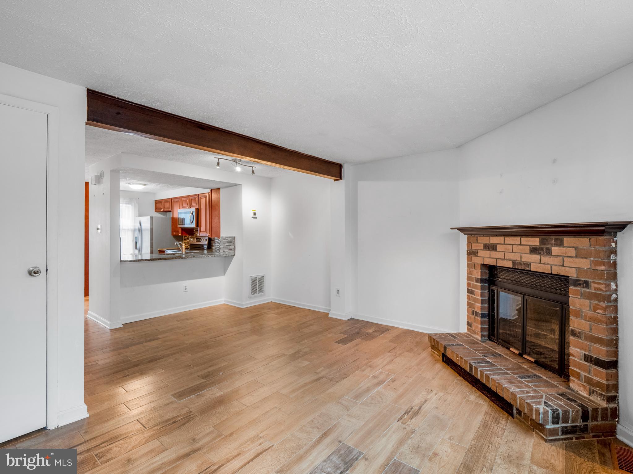 8315 Brookvale Court Springfield, VA 22153 - Photo 6 of 24 a bedroom with a bed and a fireplace