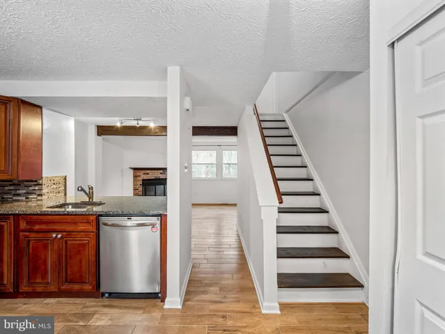 a view of a kitchen with wooden floor and electronic appliances