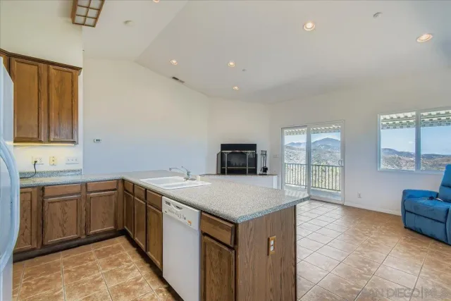 a bathroom with a granite countertop sink and a bathtub