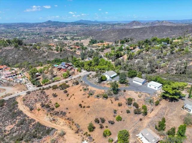 an aerial view of house yard and mountain view