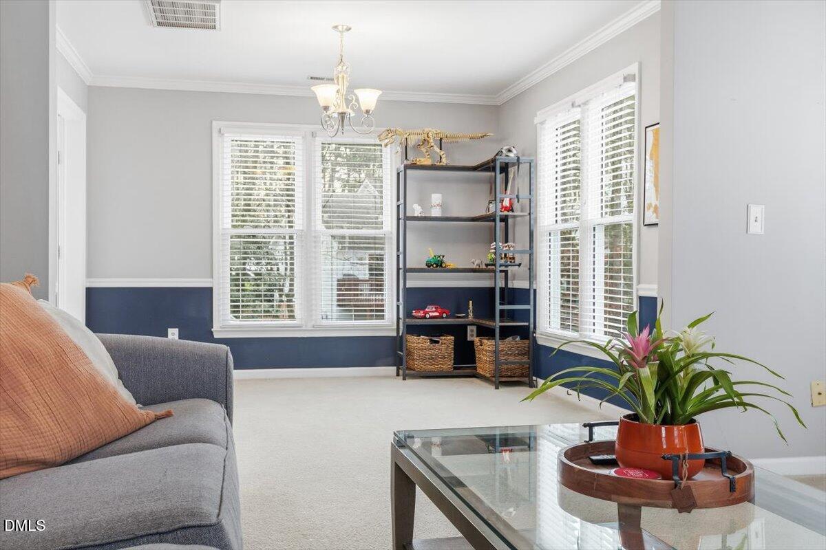 211 Kronos Lane Cary, NC 27513 - Photo 11 of 34 a living room with furniture fireplace and potted plant