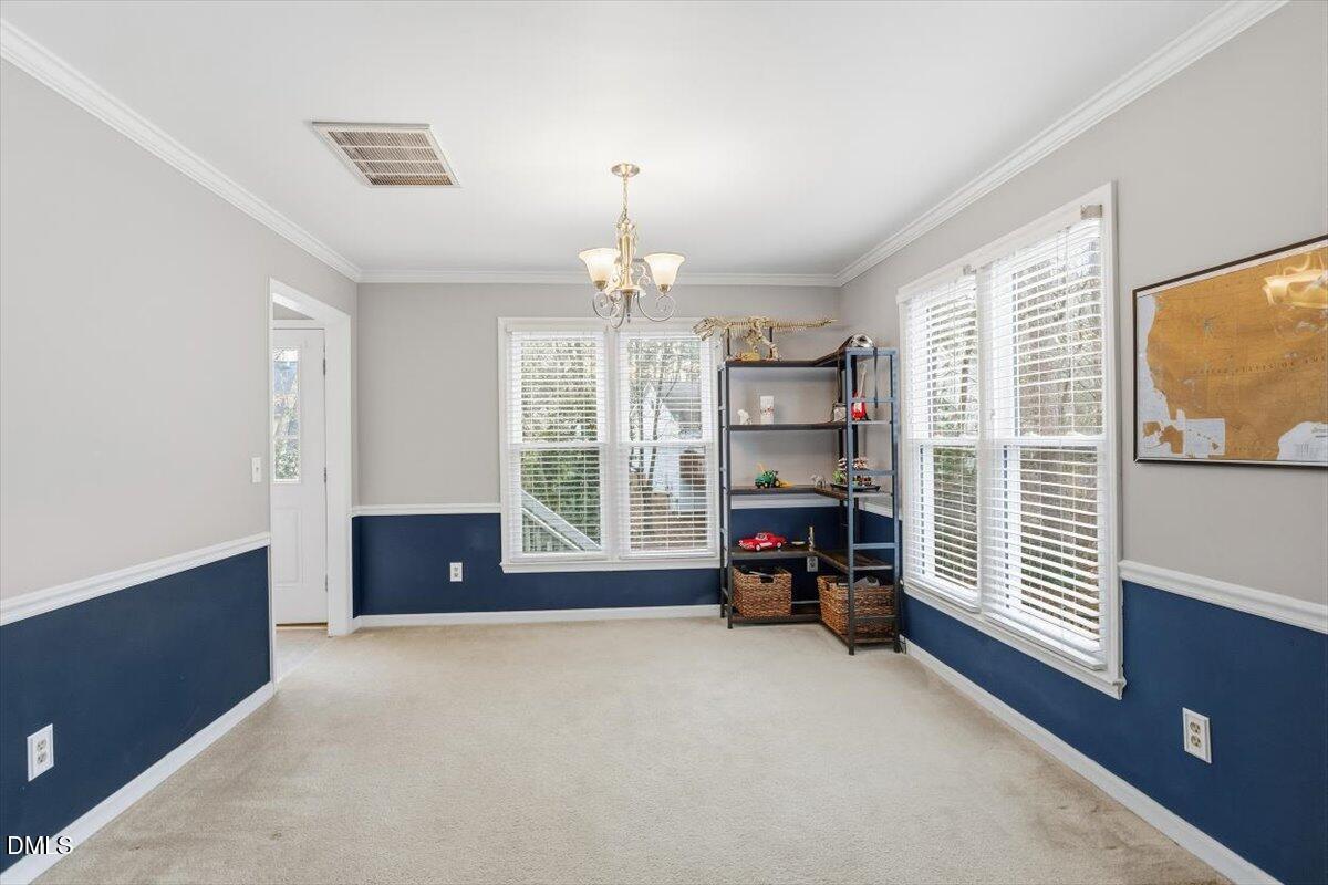 211 Kronos Lane Cary, NC 27513 - Photo 13 of 34 a living room with furniture and a chandelier