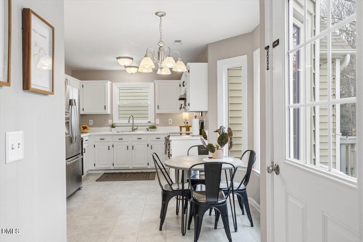 211 Kronos Lane Cary, NC 27513 - Photo 15 of 34 a view of a dining room with furniture window and outside view