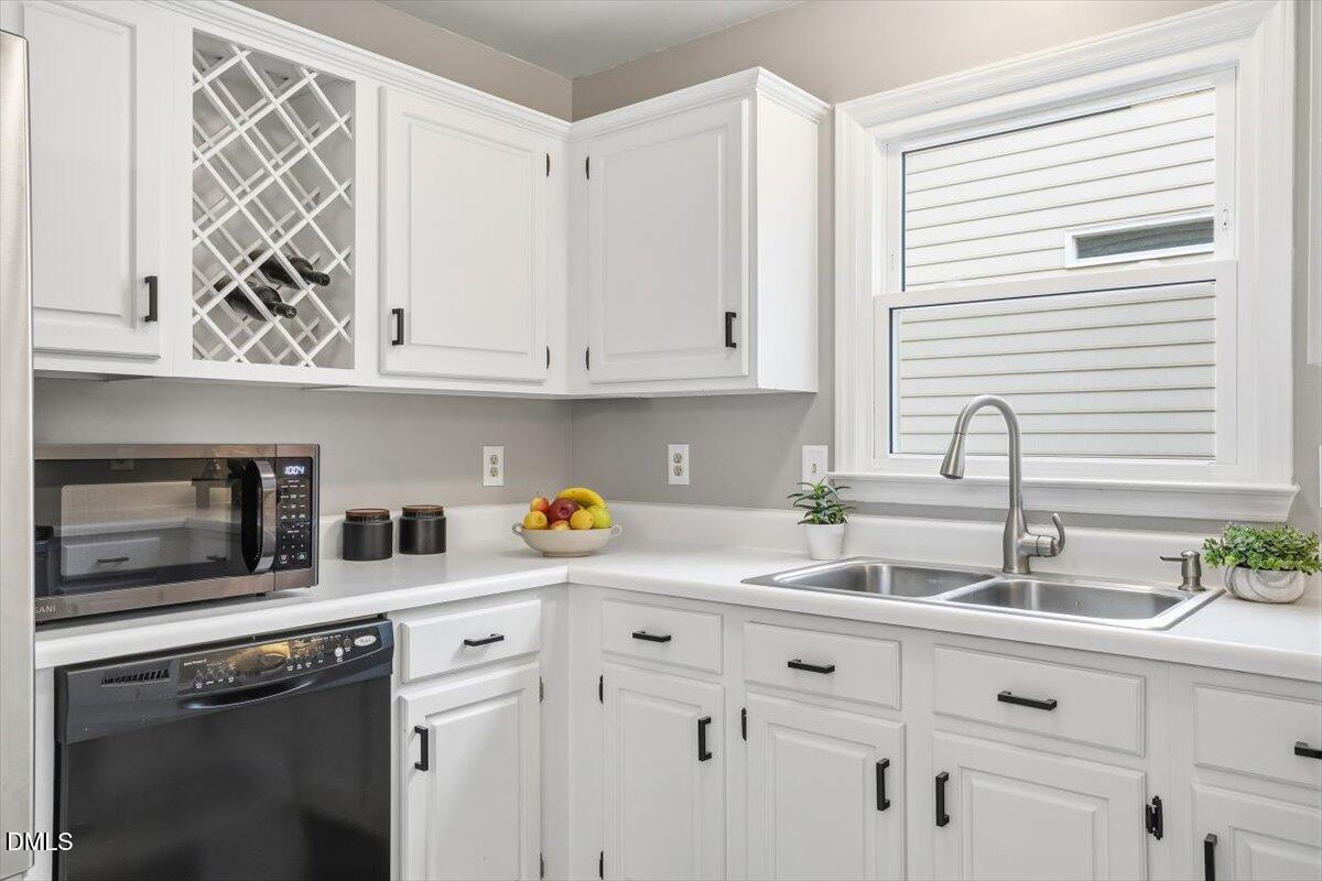 211 Kronos Lane Cary, NC 27513 - Photo 18 of 34 a kitchen with appliances cabinets and a window