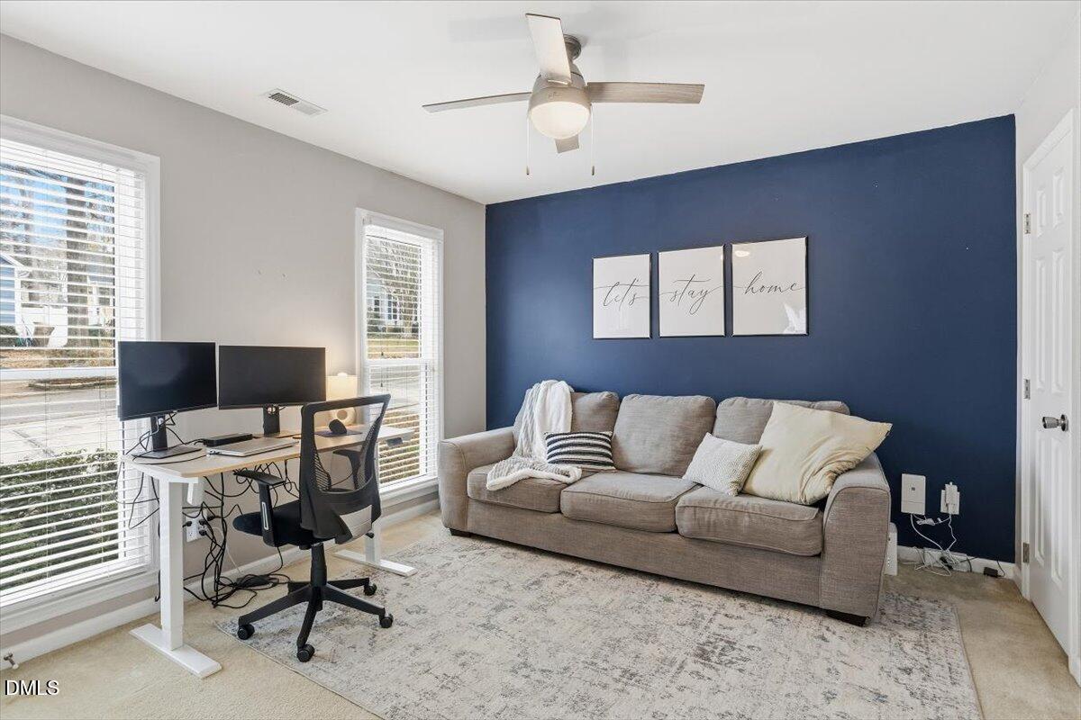 211 Kronos Lane Cary, NC 27513 - Photo 22 of 34 a living room with furniture and a flat screen tv