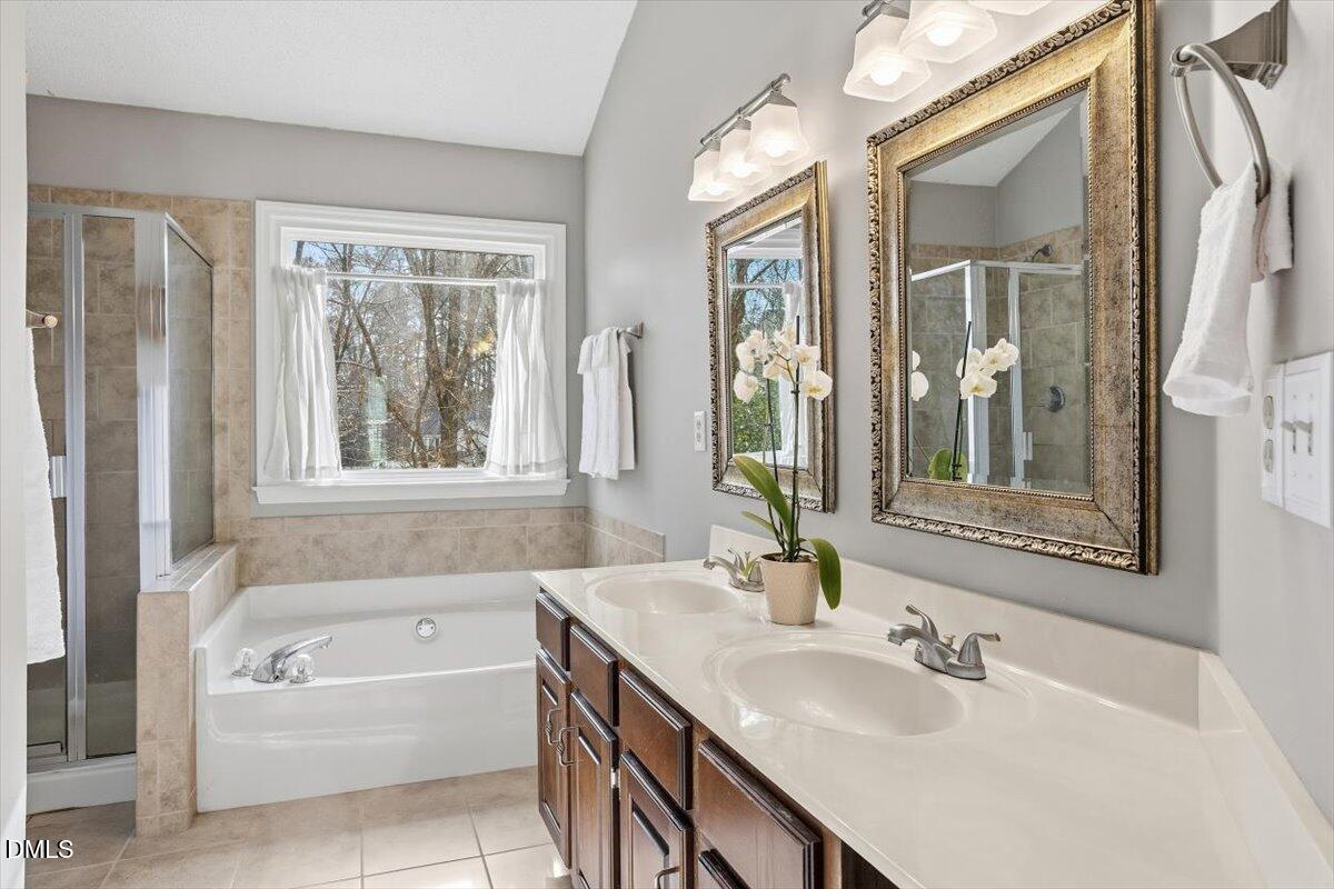 211 Kronos Lane Cary, NC 27513 - Photo 32 of 34 a bathroom with a tub sink and mirror