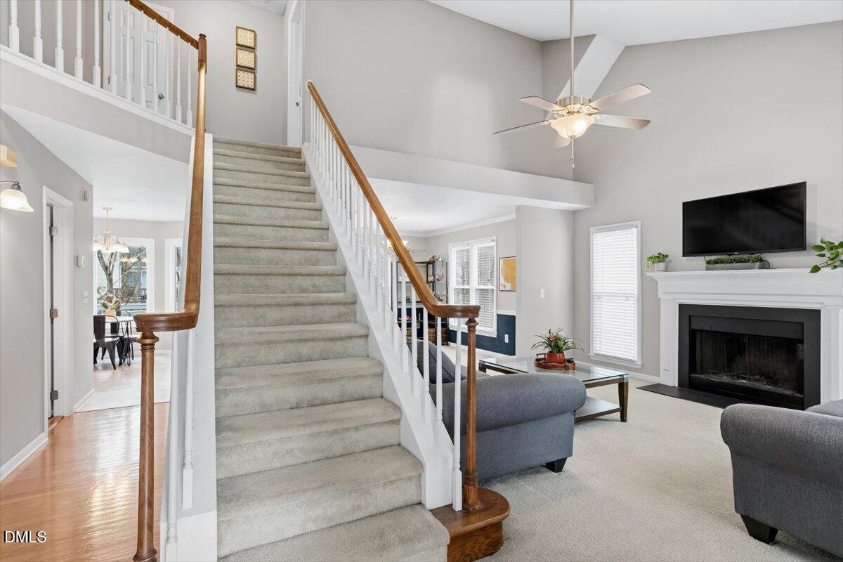 211 Kronos Lane Cary, NC 27513 - Photo 8 of 34 a living room with furniture a flat screen tv and a fireplace