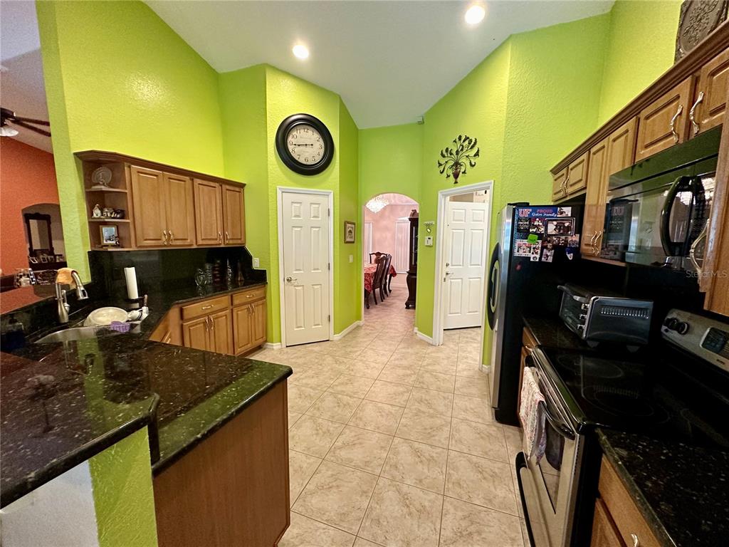 2576 Southwest 175 Loop Ocala, FL 34473 - Photo 16 of 62 a kitchen with a stove and a refrigerator