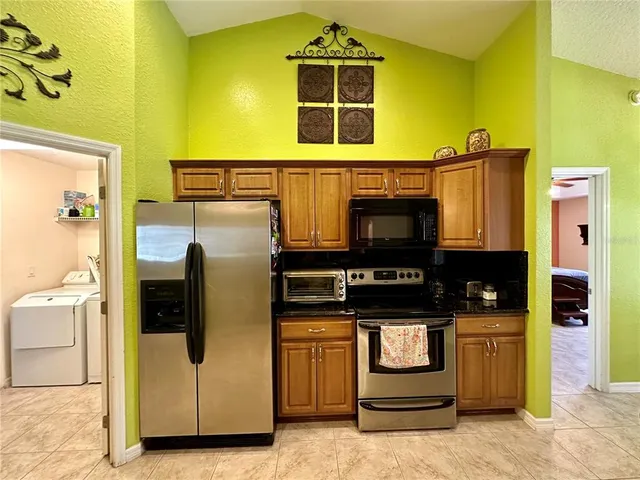 a kitchen with stainless steel appliances granite countertop a stove and a refrigerator