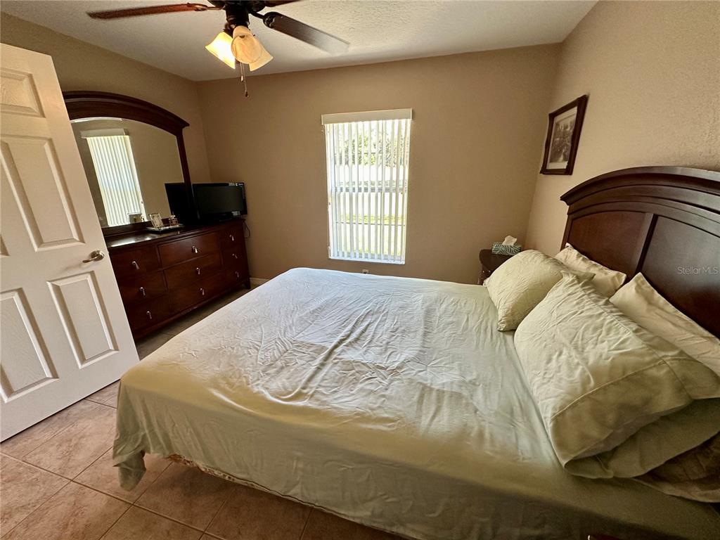 2576 Southwest 175 Loop Ocala, FL 34473 - Photo 29 of 62 a bedroom with a bed and a mirror