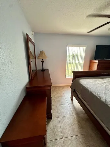 a bedroom with a bed and a mirror