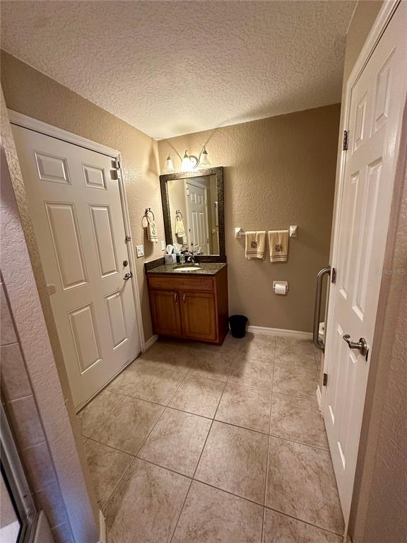 2576 Southwest 175 Loop Ocala, FL 34473 - Photo 38 of 62 a kitchen with granite countertop a refrigerator and a stove top oven