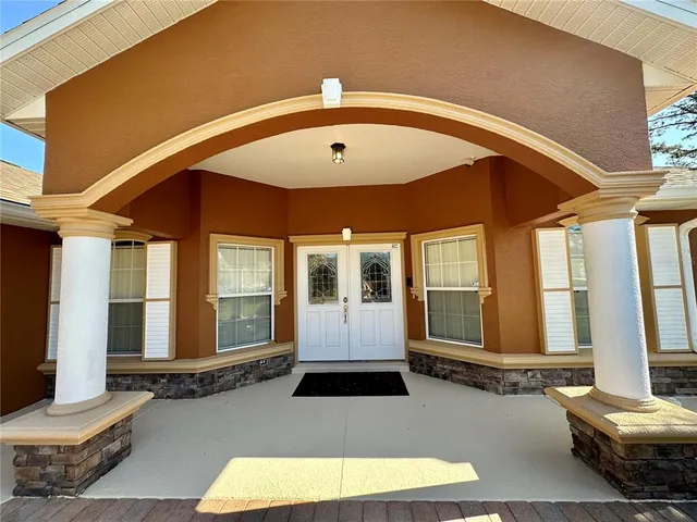 a view of a swimming pool with an outdoor seating