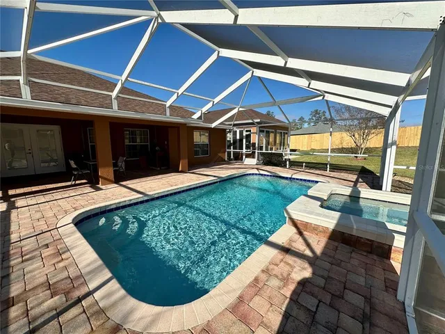 a front view of a house with swimming pool having outdoor seating