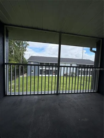 a view of porch with a small yard