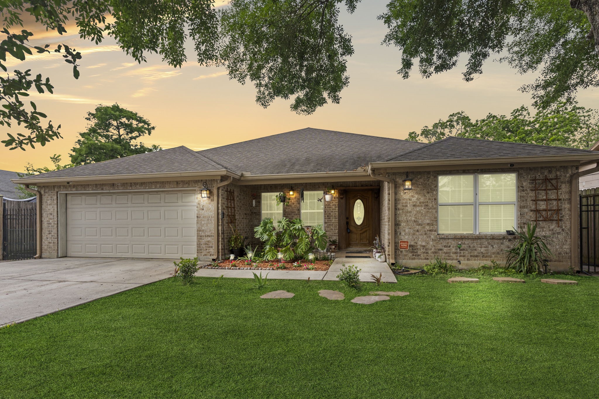 a front view of a house with a garden and yard