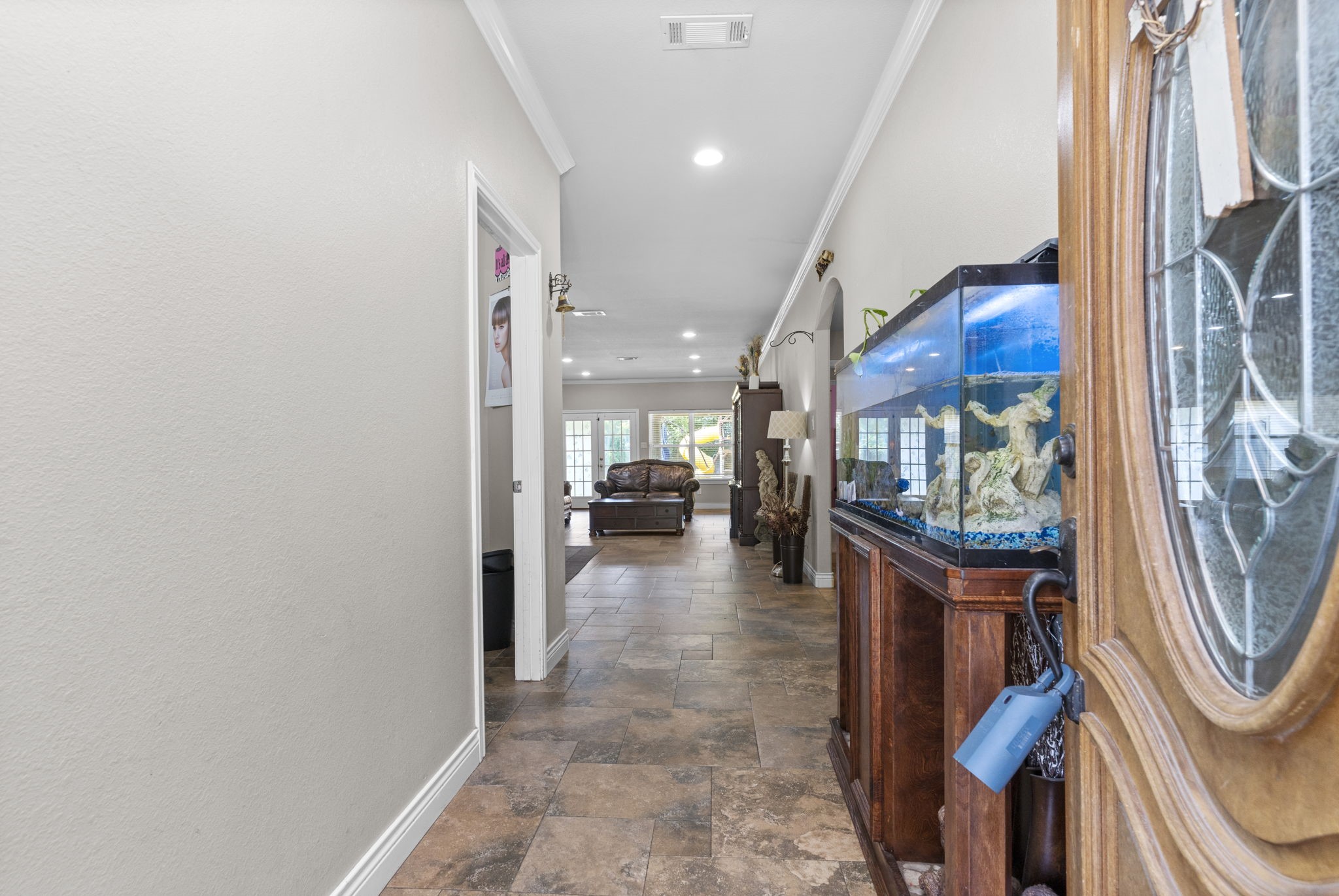 631 Apache Street Houston, TX 77022 - Photo 18 of 45 a view of a hallway with furniture and a fireplace