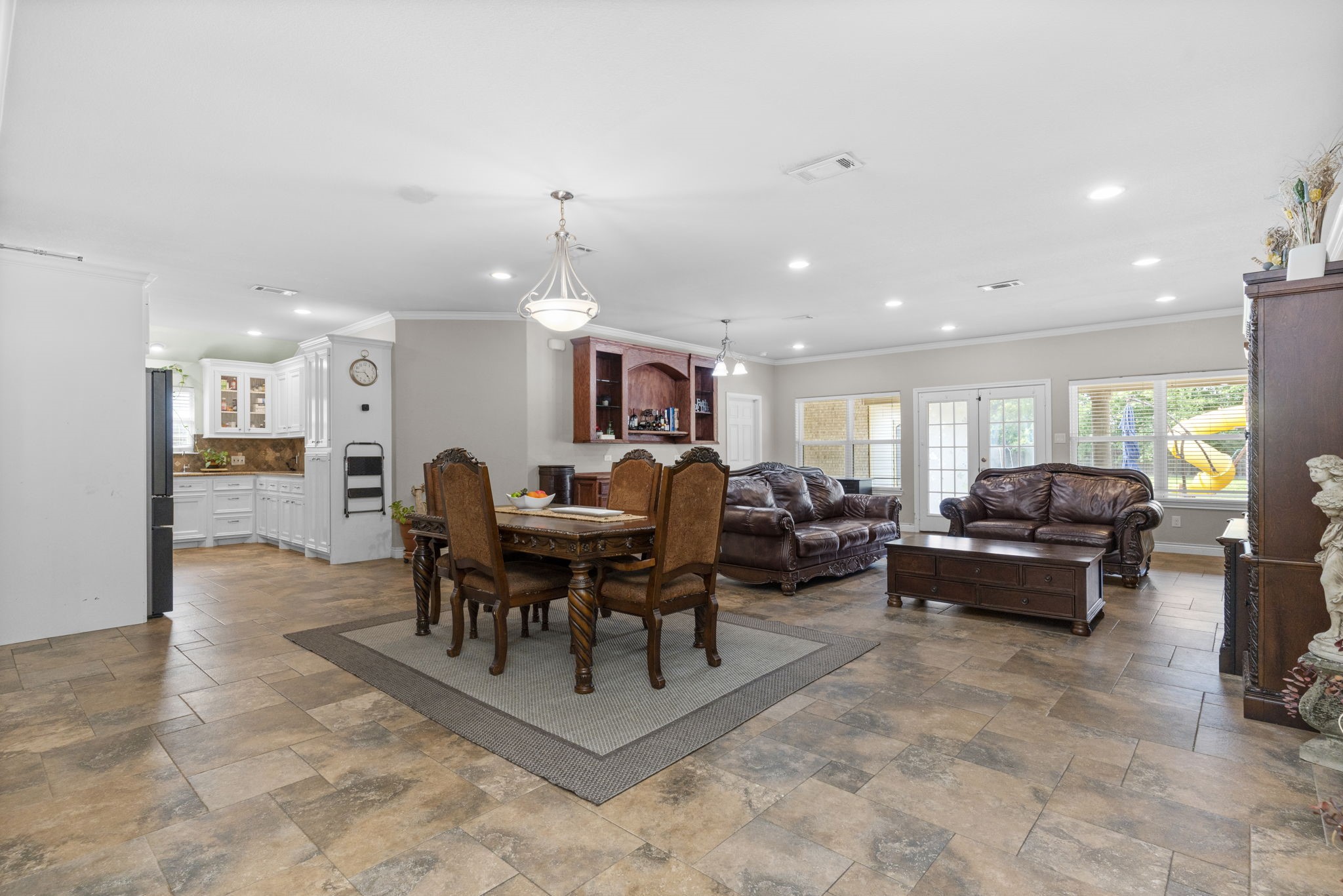 631 Apache Street Houston, TX 77022 - Photo 20 of 45 a living room with furniture a table and kitchen view