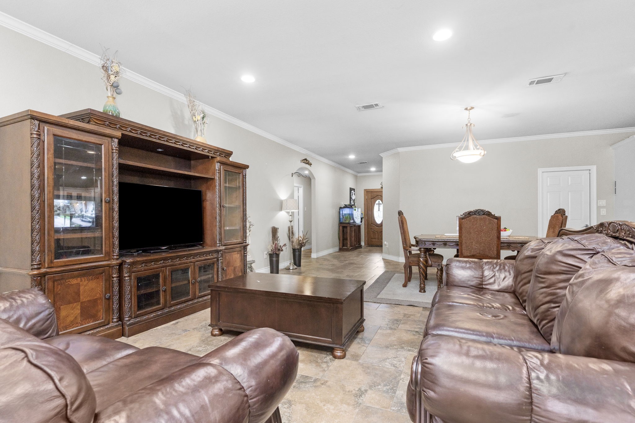 631 Apache Street Houston, TX 77022 - Photo 22 of 45 a living room with furniture a flat screen tv and kitchen view