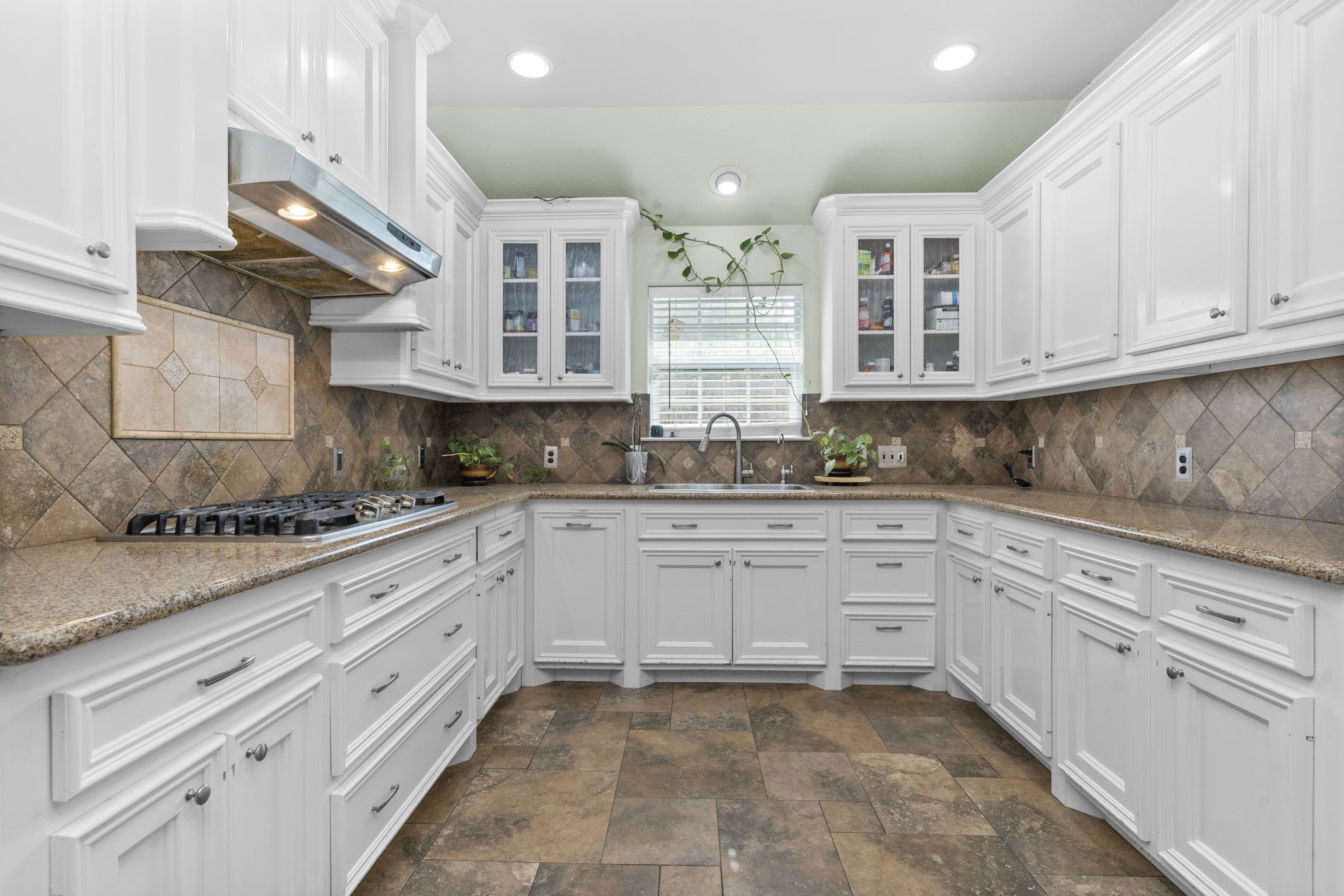 631 Apache Street Houston, TX 77022 - Photo 26 of 45 a kitchen with stainless steel appliances granite countertop a sink and cabinets