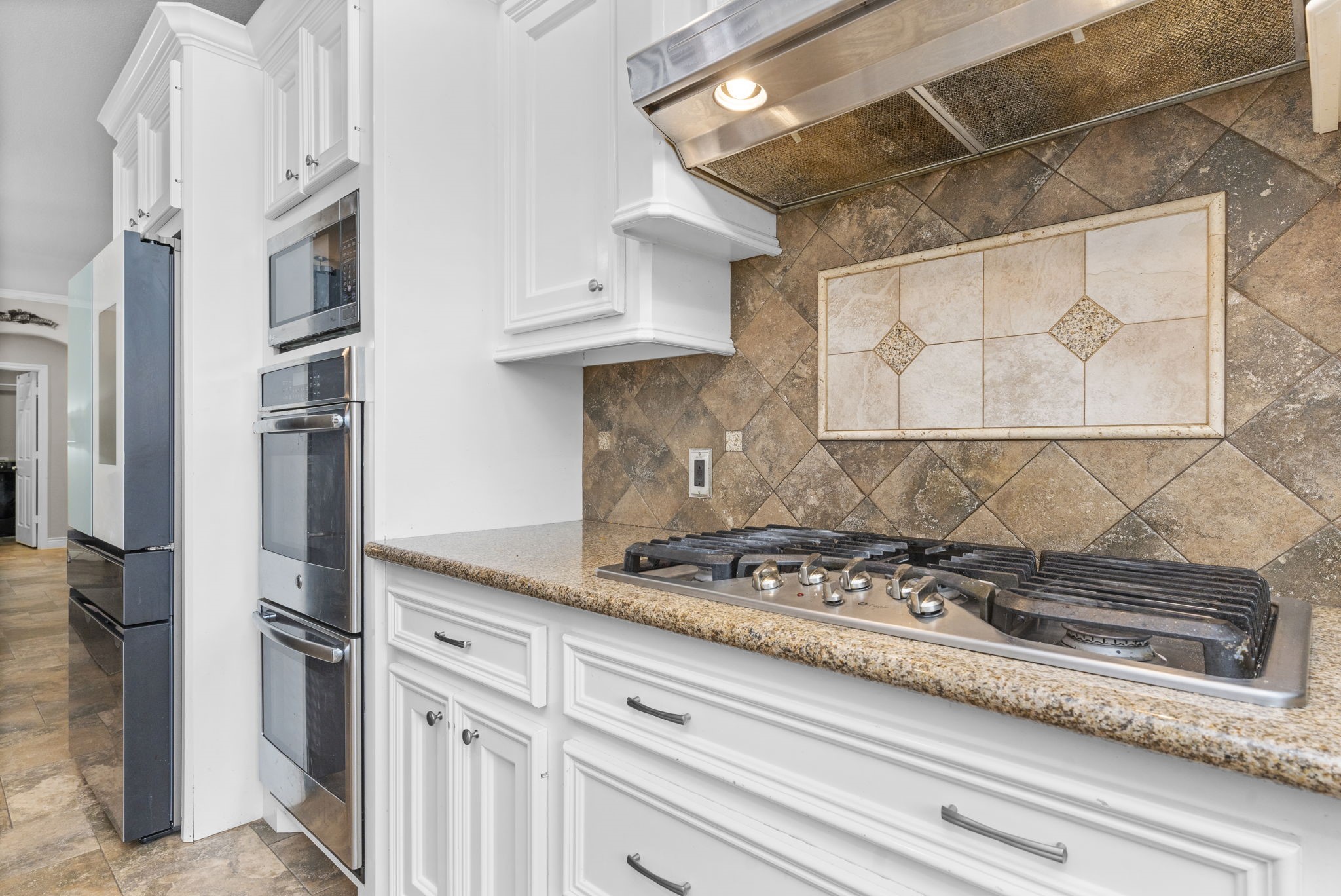 631 Apache Street Houston, TX 77022 - Photo 27 of 45 a kitchen with stainless steel appliances granite countertop a stove and a refrigerator