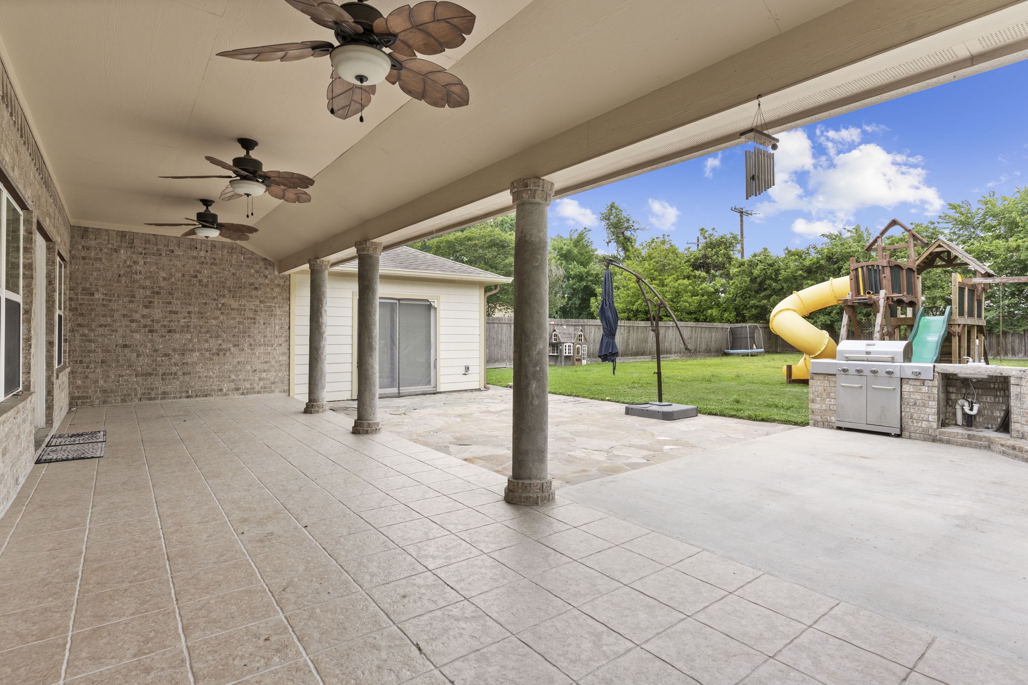 631 Apache Street Houston, TX 77022 - Photo 30 of 45 a view of a porch with a floor to ceiling window and a yard