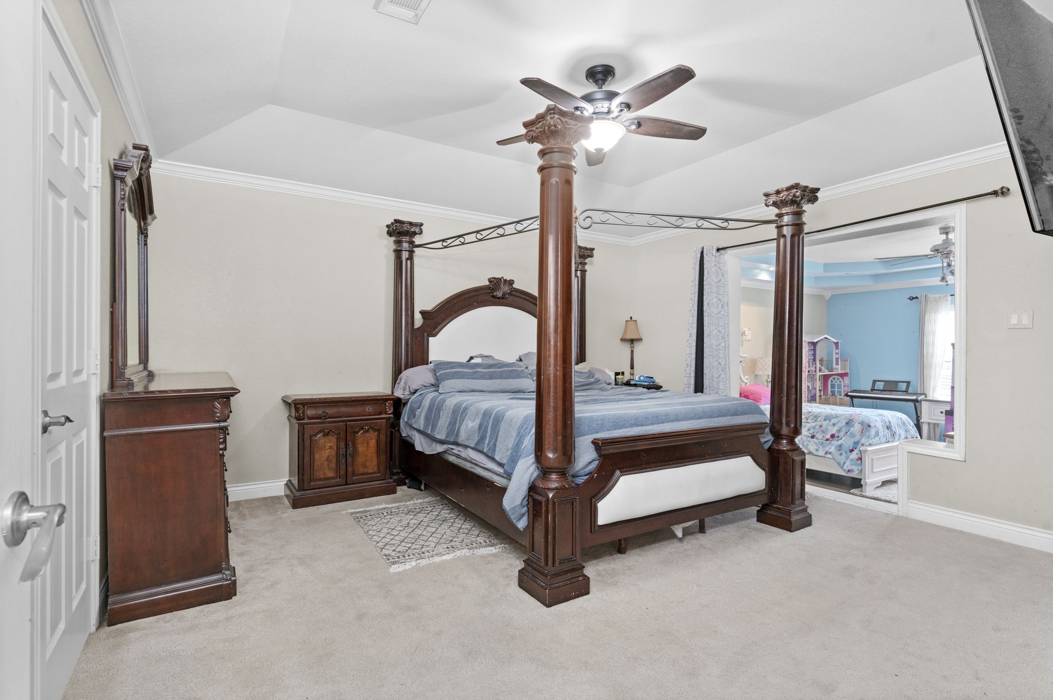 631 Apache Street Houston, TX 77022 - Photo 38 of 45 a bedroom with a bed and a chandelier