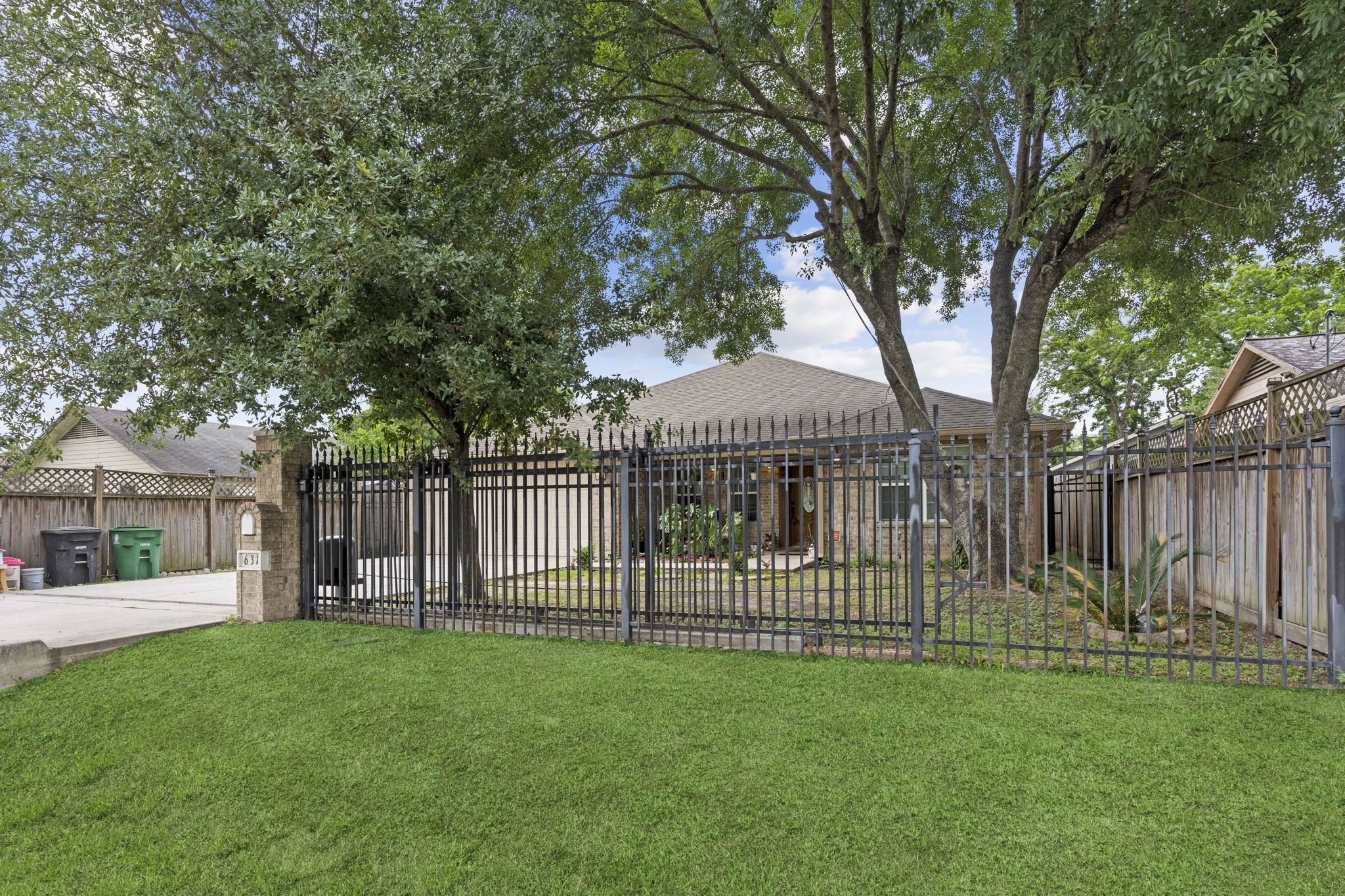 631 Apache Street Houston, TX 77022 - Photo 4 of 45 a view of a park with a large tree and wooden fence