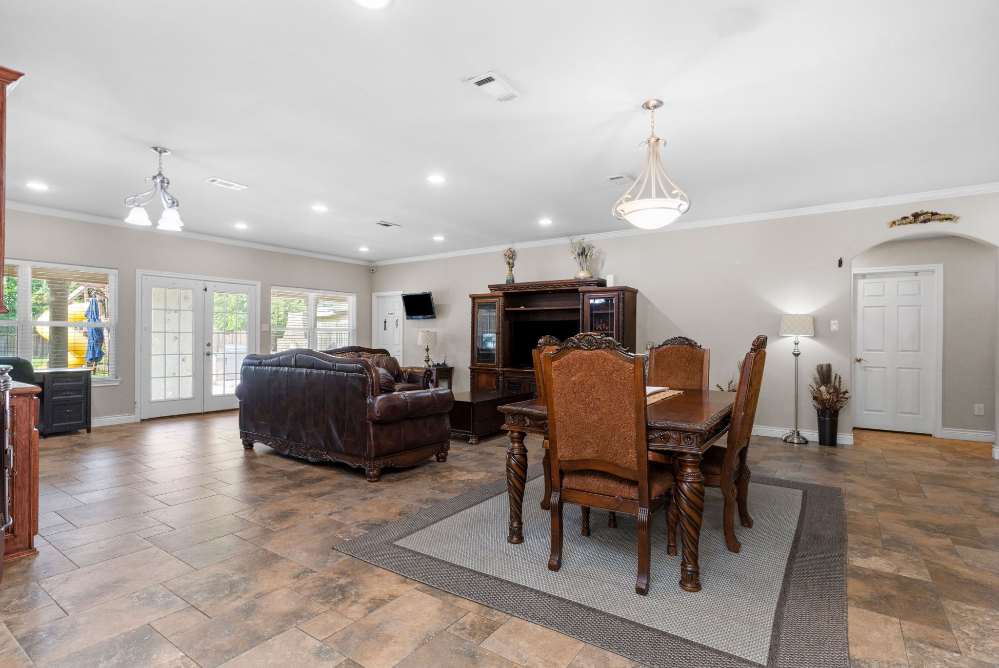 631 Apache Street Houston, TX 77022 - Photo 41 of 45 a living room with furniture a dining table and a fireplace