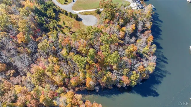 an aerial view of lake and residential houses with outdoor space