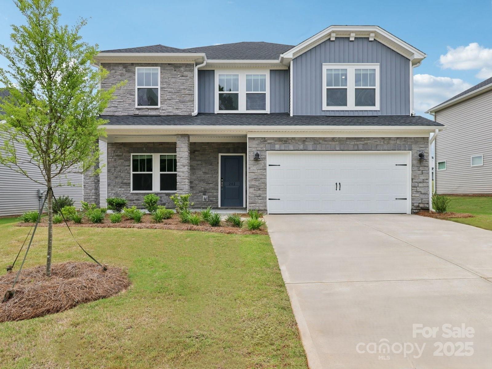 202 Nelson Crk Road Mocksville, NC 27028 - Photo 1 of 11 a front view of a house with a yard and garage