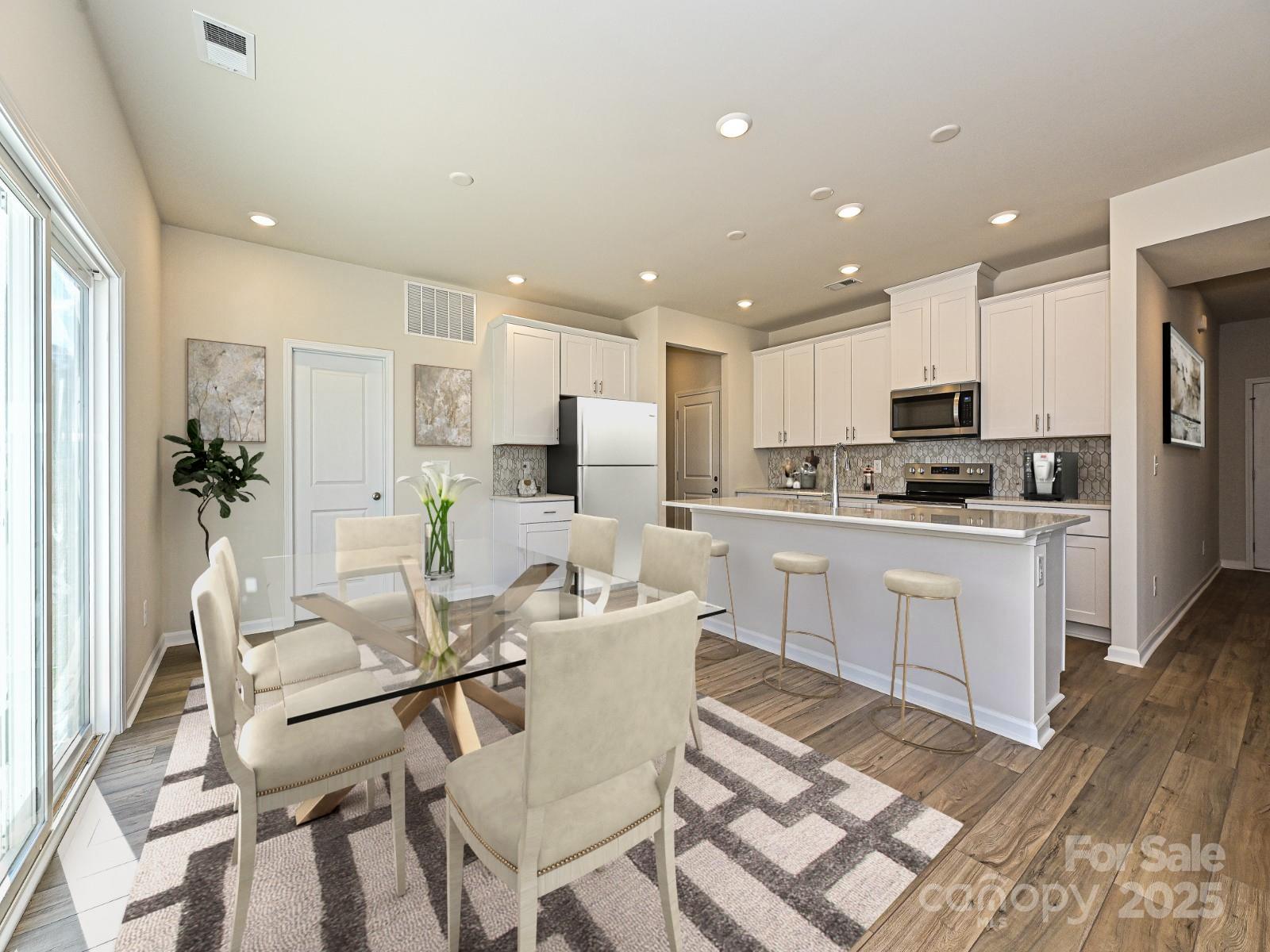 202 Nelson Crk Road Mocksville, NC 27028 - Photo 2 of 11 a kitchen with kitchen island white cabinets and stainless steel appliances