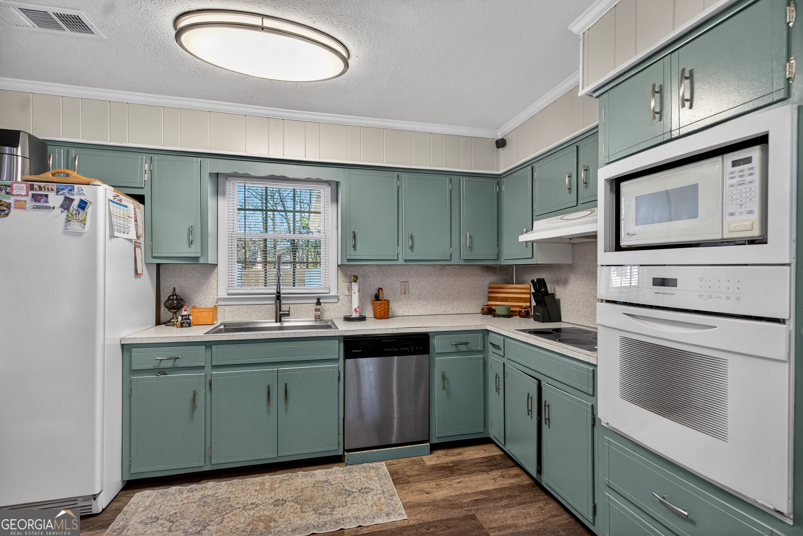 2404 19th Avenue Valley, AL 36854 - Photo 11 of 24 a kitchen with a sink a stove and cabinets