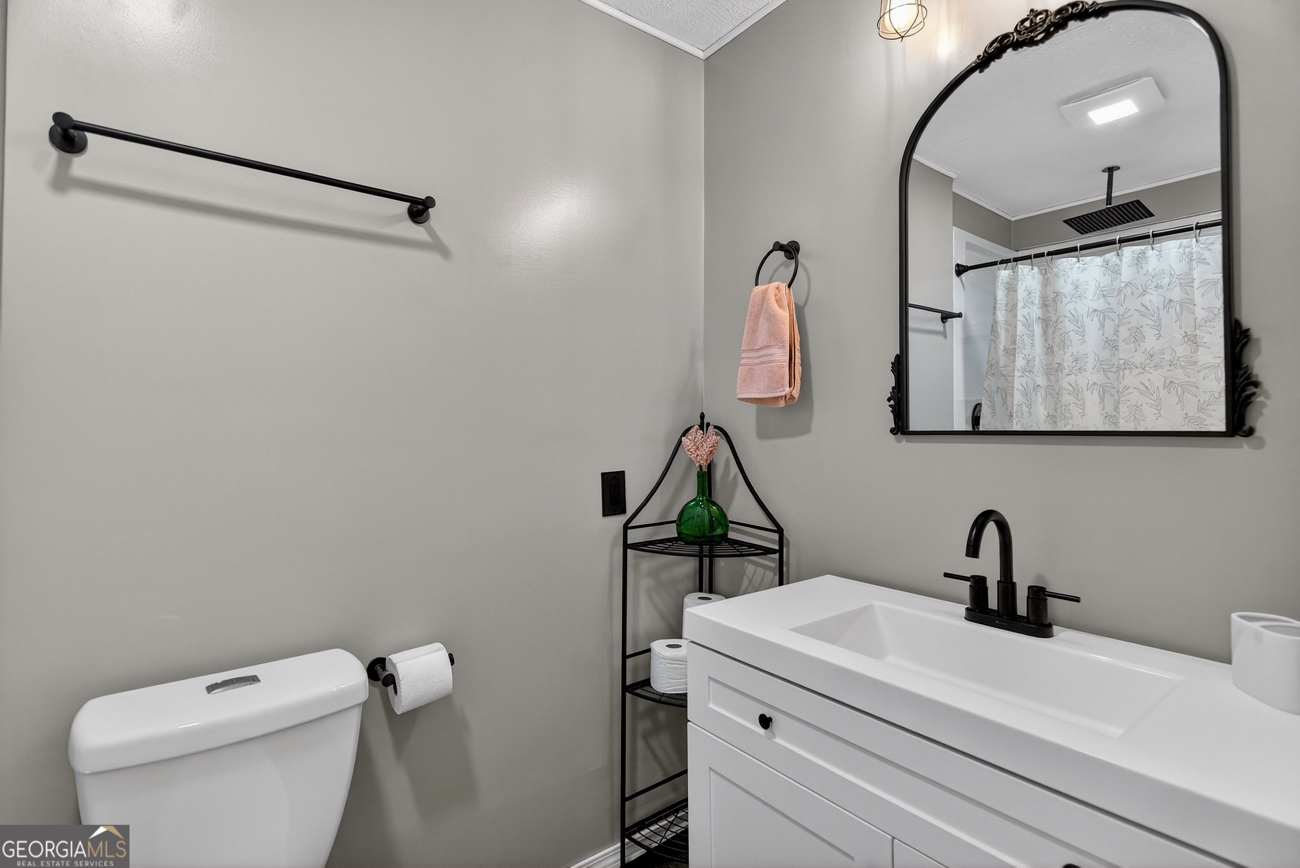 2404 19th Avenue Valley, AL 36854 - Photo 15 of 24 a bathroom with a sink a toilet and mirror